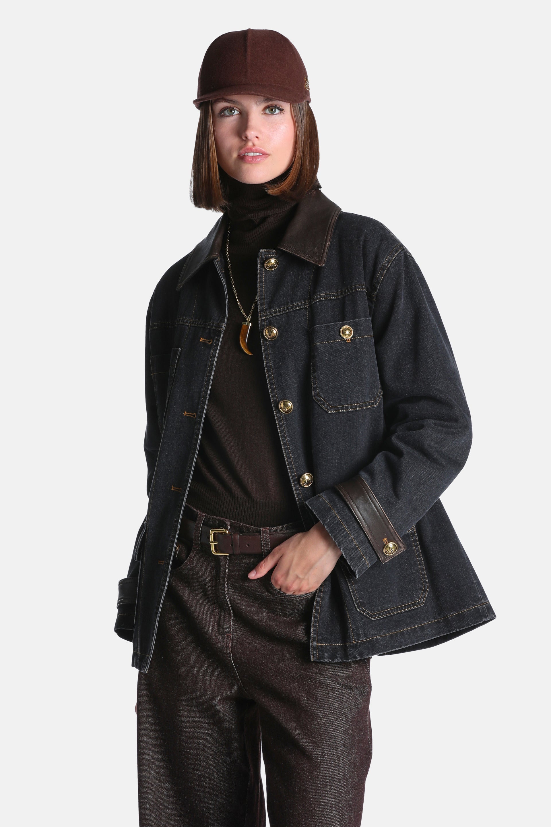 Dark black-brown denim coat with a brown leather-look collar and cuff trim. Features gold-toned buttons and four front pocket