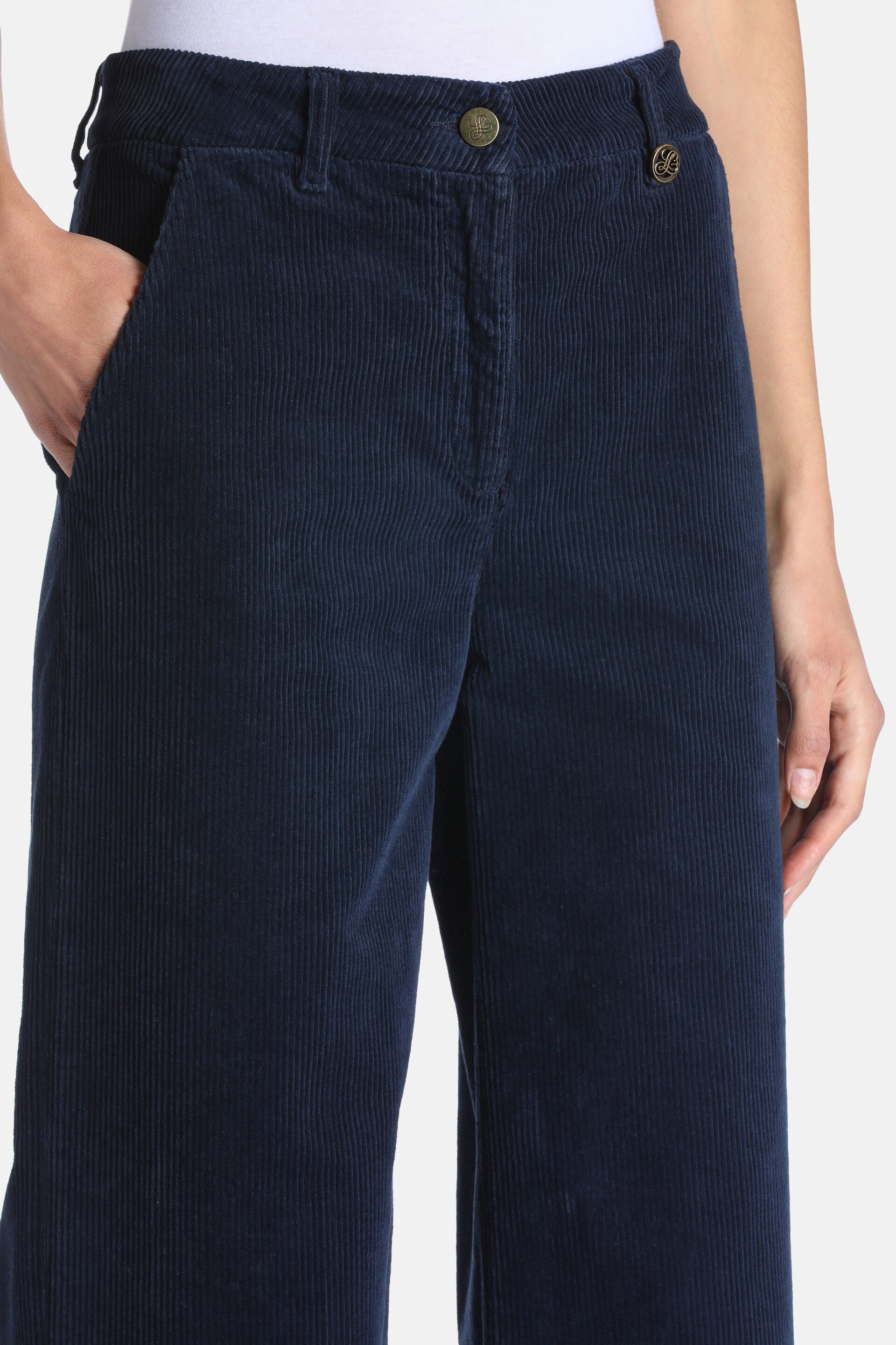 Navy corduroy wide-leg trousers with a front zip fly, gold-toned embossed buttons, and side slash pockets.