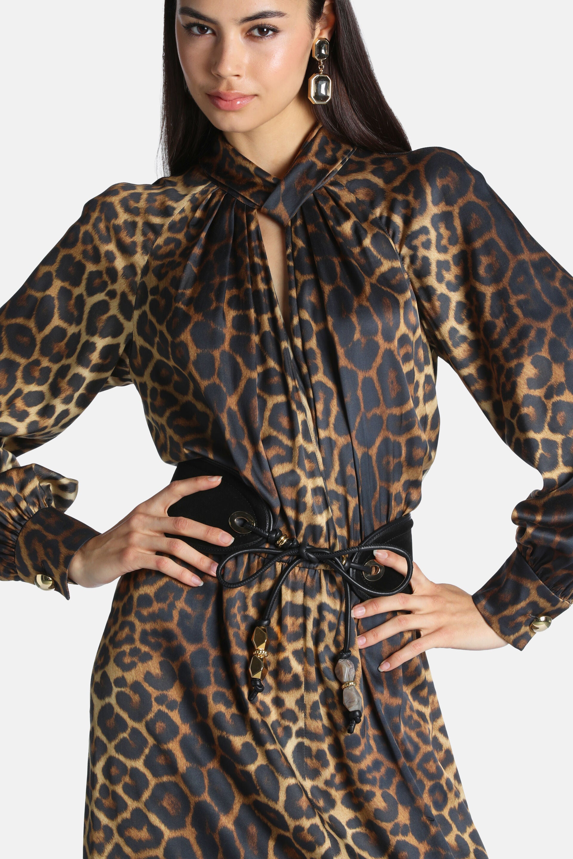 Leopard print dress with twisted mock neck, balloon sleeves, gold-toned button cuffs, and black faux leather tie belt with be