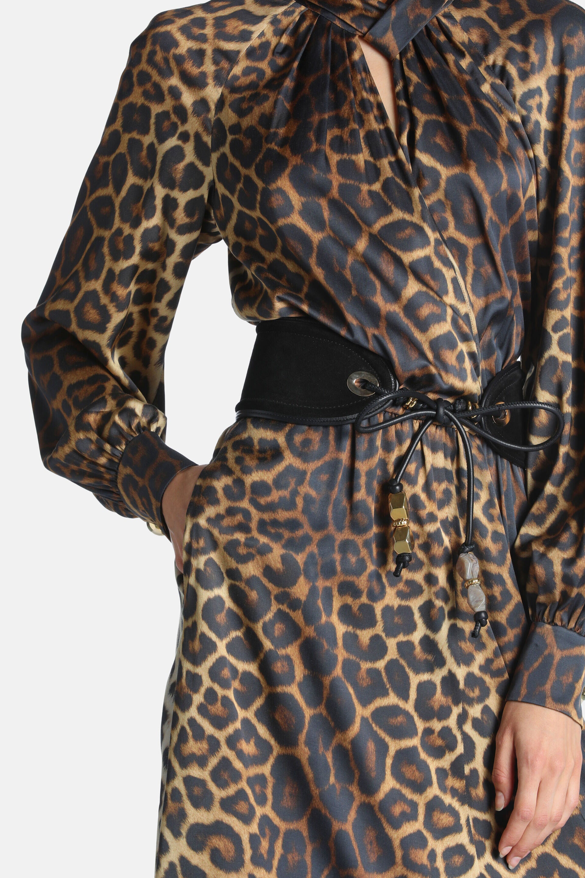 Leopard print dress with a twisted V-neck, long gathered sleeves, and a black elasticated belt with beaded leather ties.