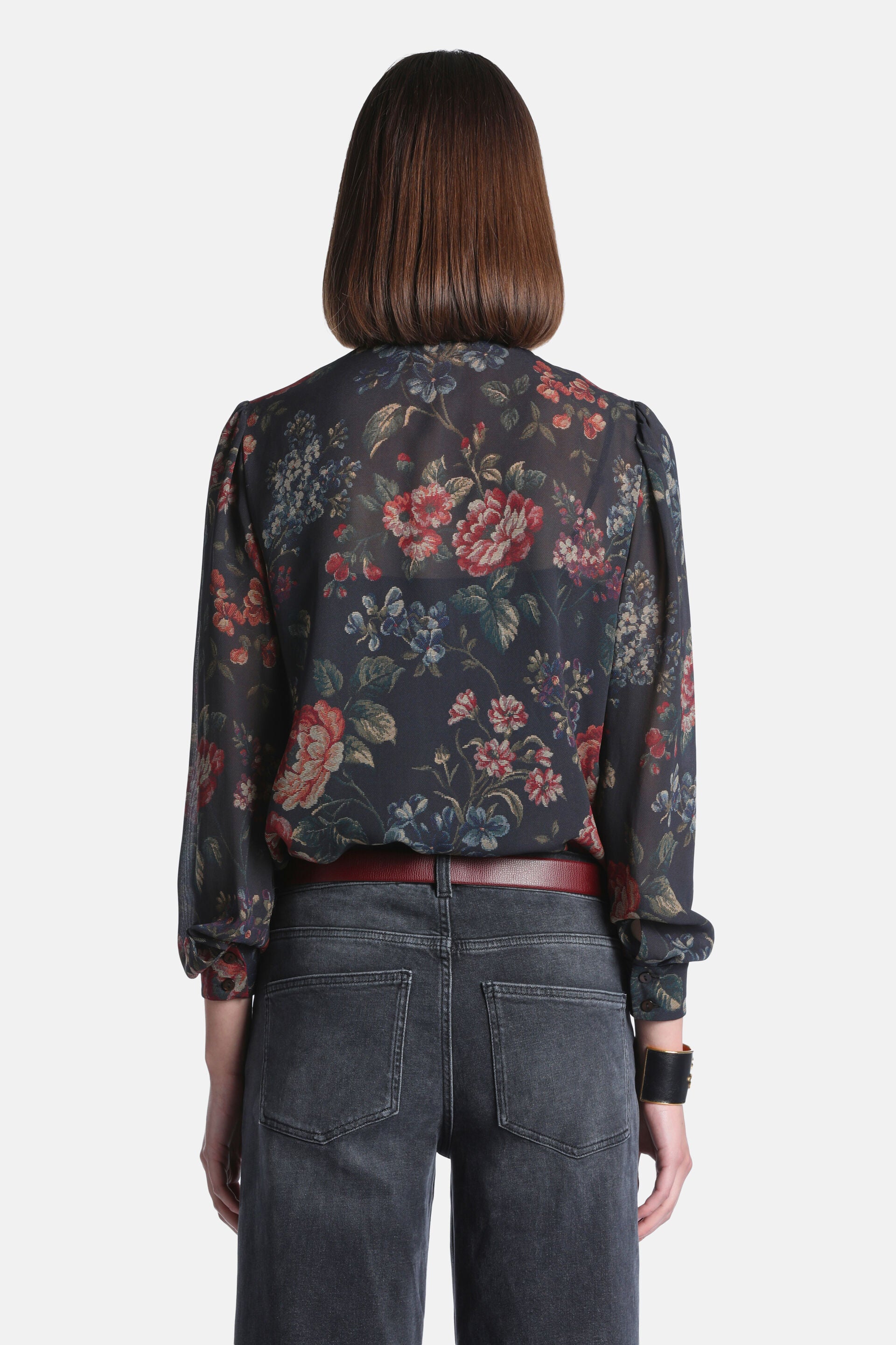 Dark brown floral print sheer long-sleeved shirt with gathered shoulders, gathered cuffs, and a gathered hem.