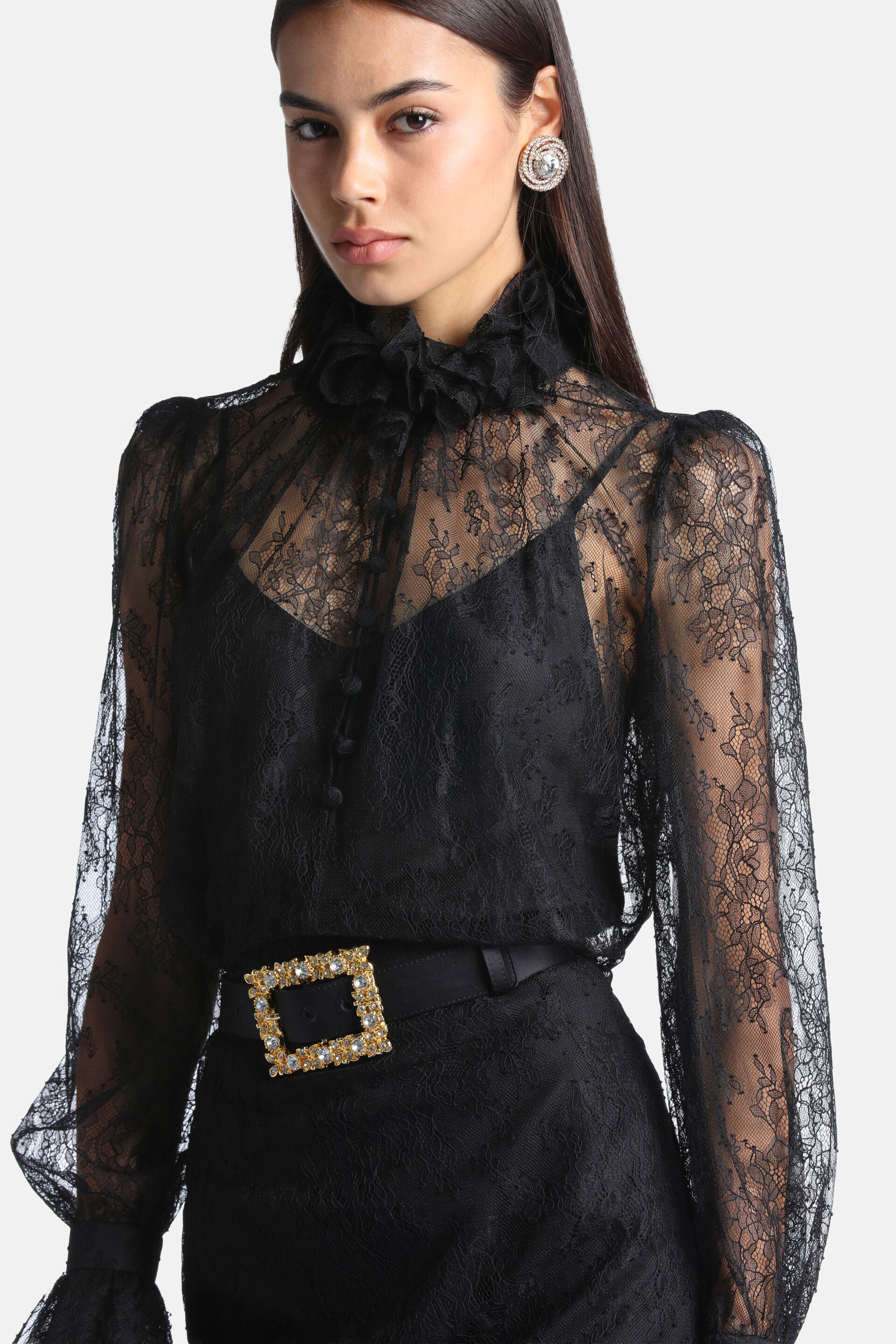 Black sheer lace shirt with a ruffled high neck, button-down front, puffed shoulders, and long ruffled sleeves.