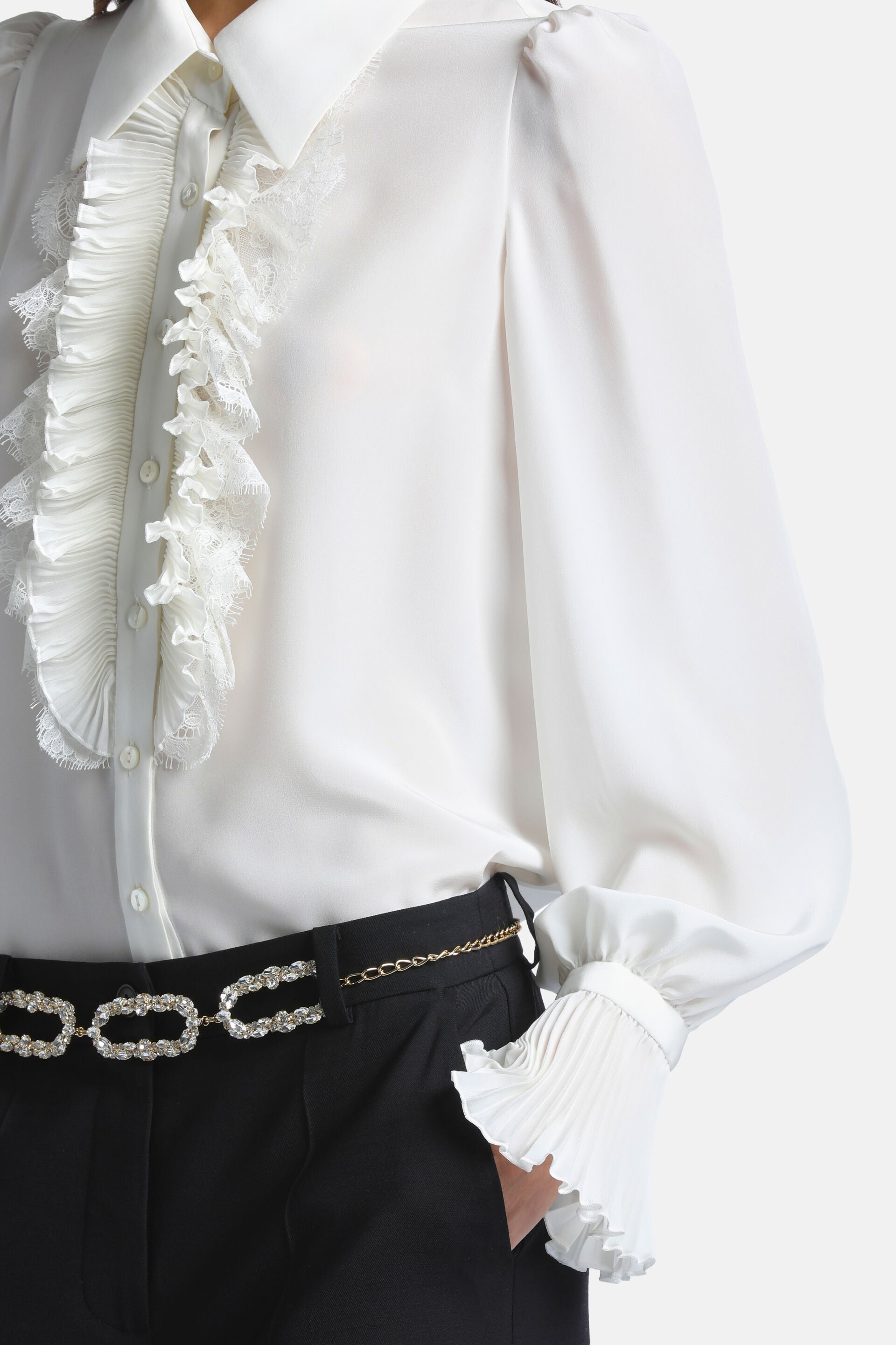 Ivory long-sleeve shirt with a pointed collar, button-down front, pleated ruffles with lace trim, and wide pleated cuffs.