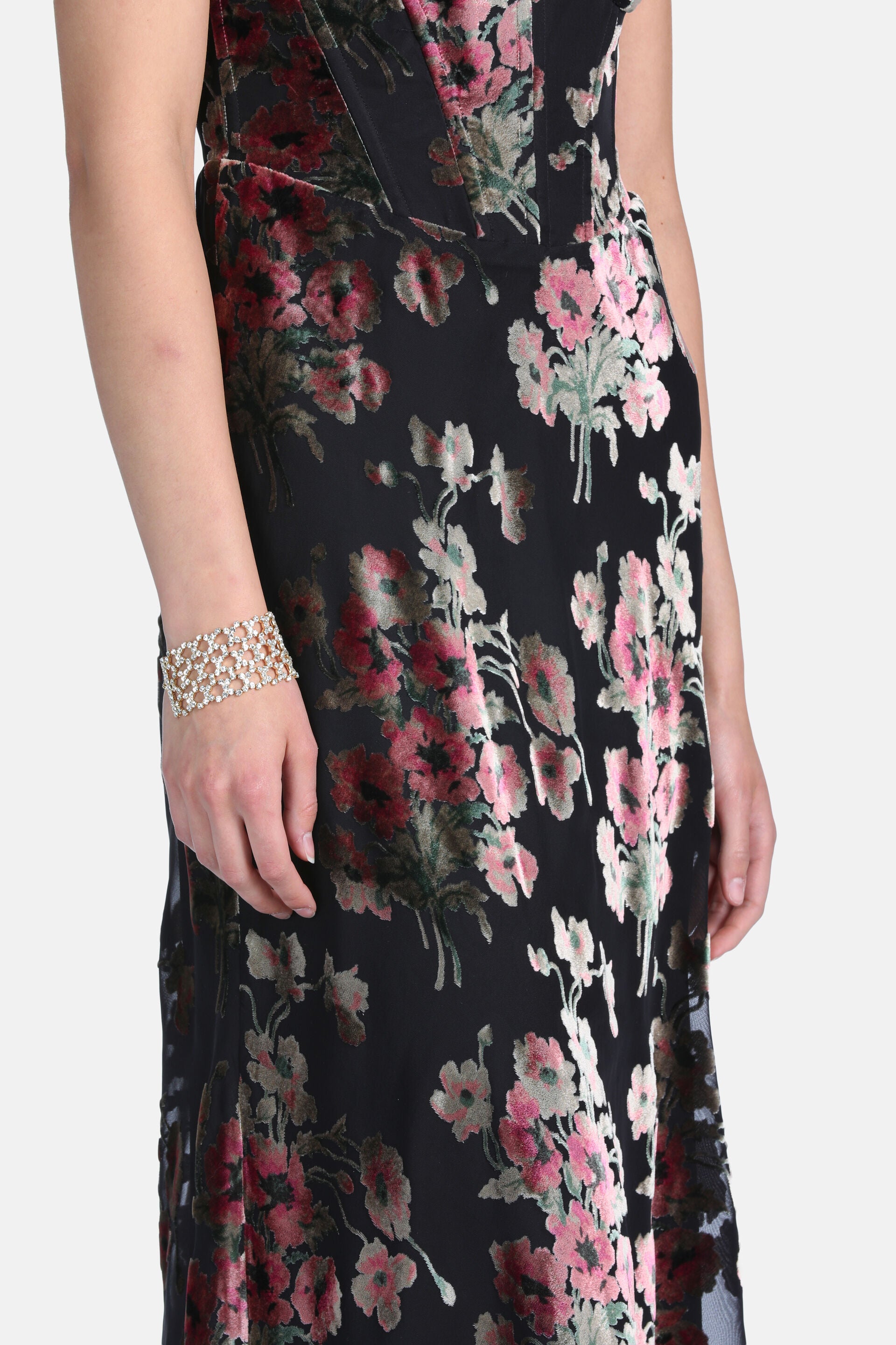 Black burnout velvet dress with pink and red floral patterns and green leaves. Features a fitted bodice.
