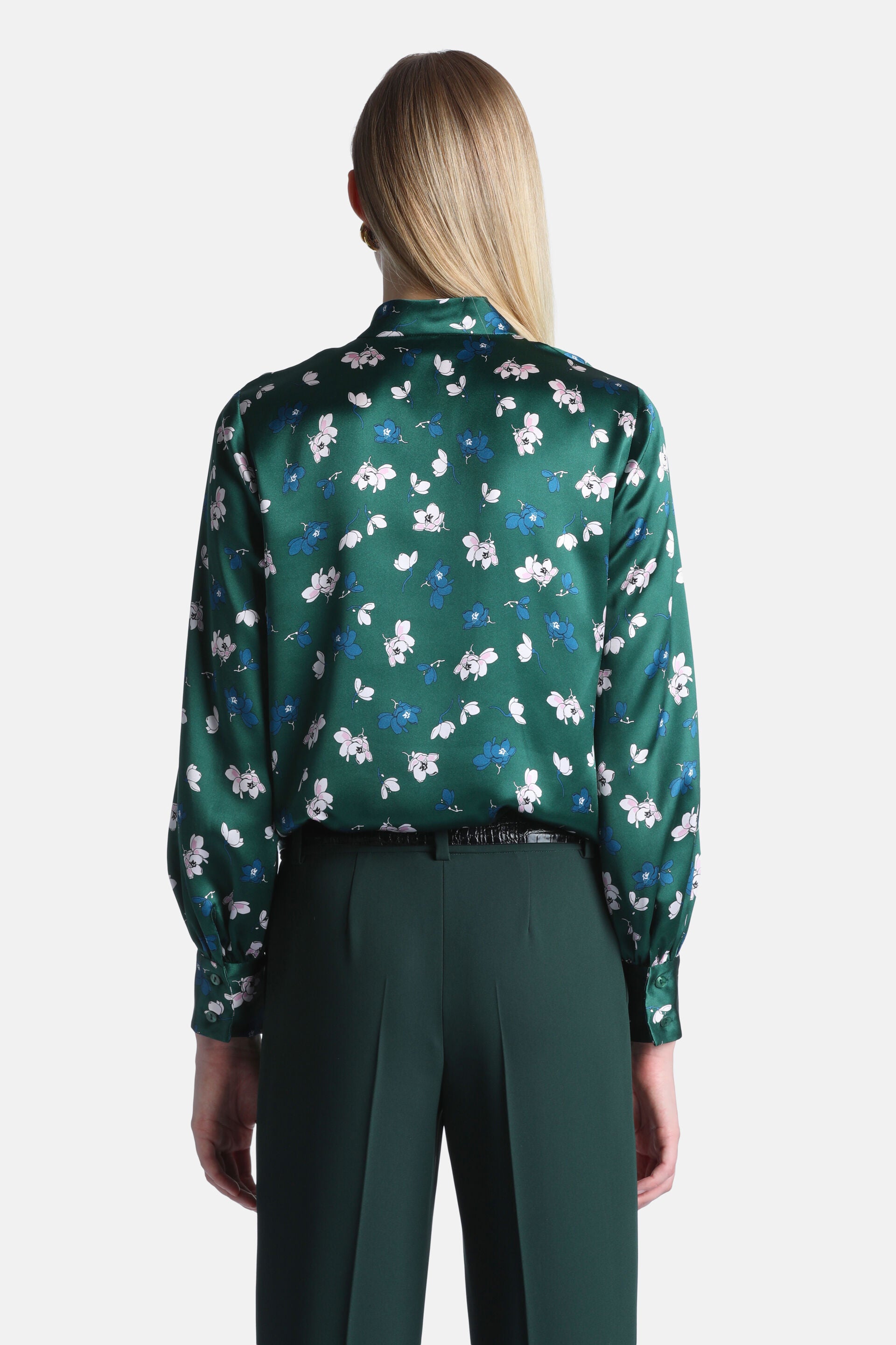 Emerald green satin shirt with scattered small white, light pink, and blue floral print. Long sleeves with cuffs and a collar