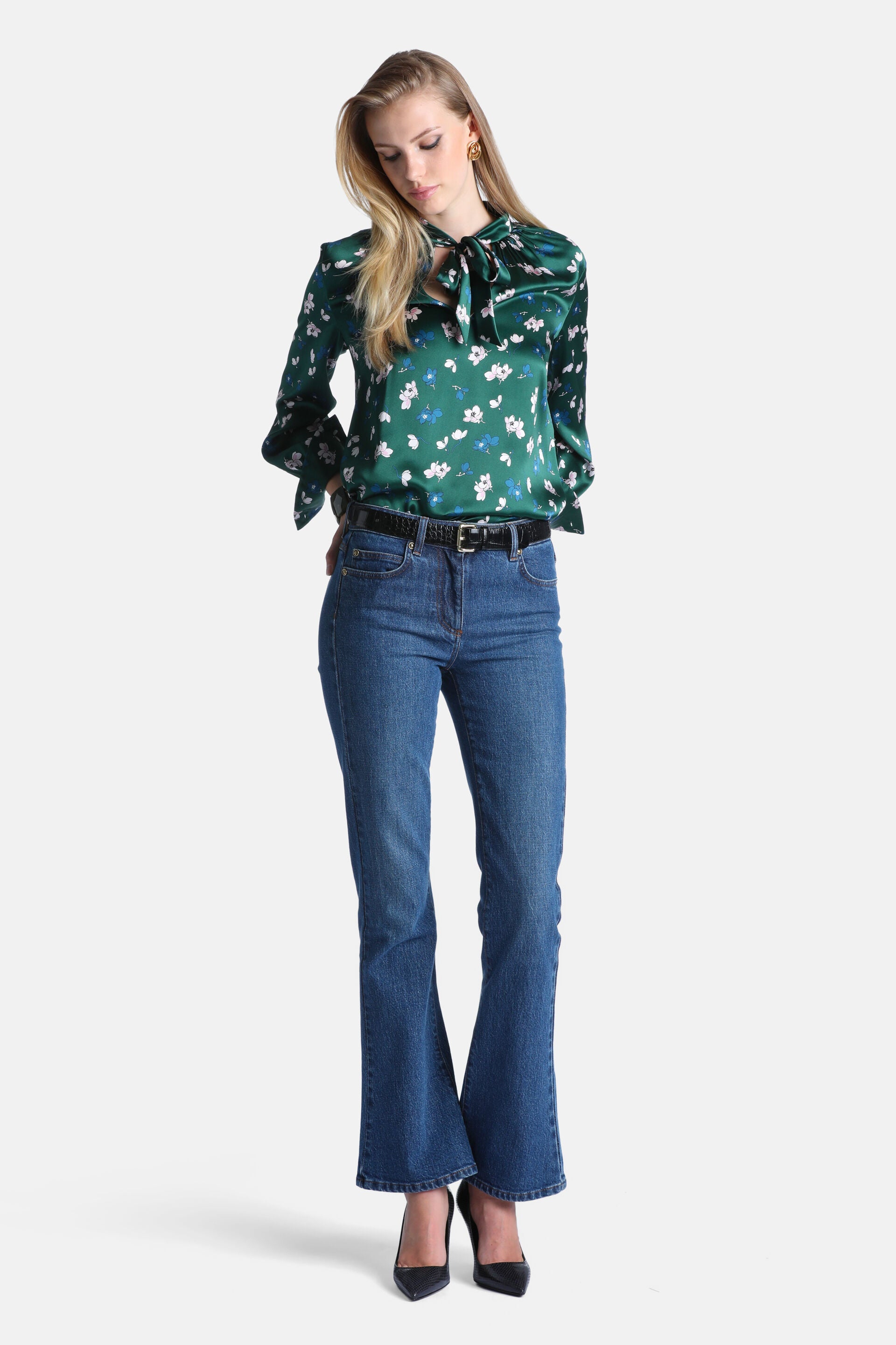 Green satin blouse with white and blue floral print, pussy-bow tie neck, and long flared sleeves.