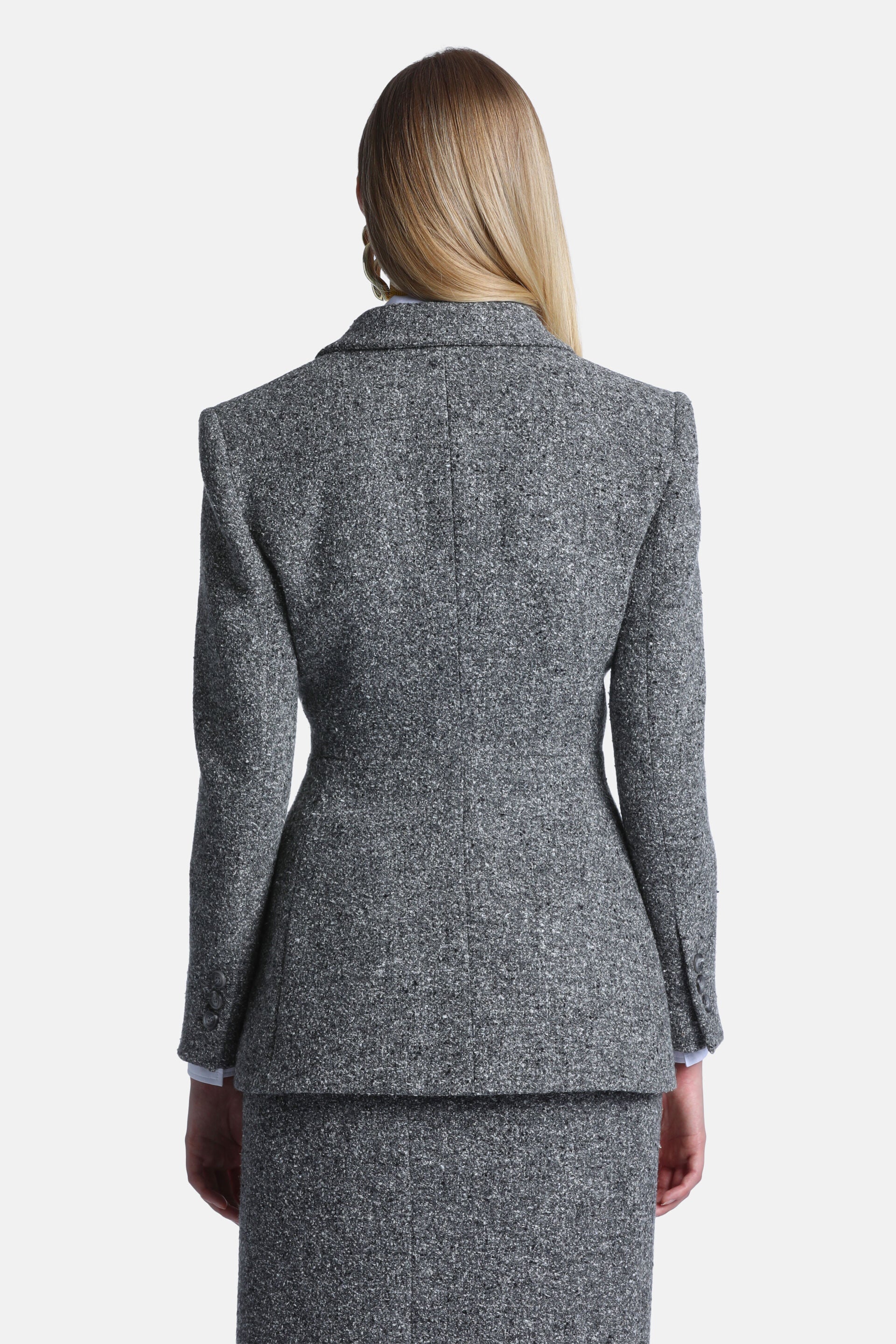 Grey-cream flecked tweed-style jacket, seen from the back, with a notched collar, long sleeves, and three buttons on the left