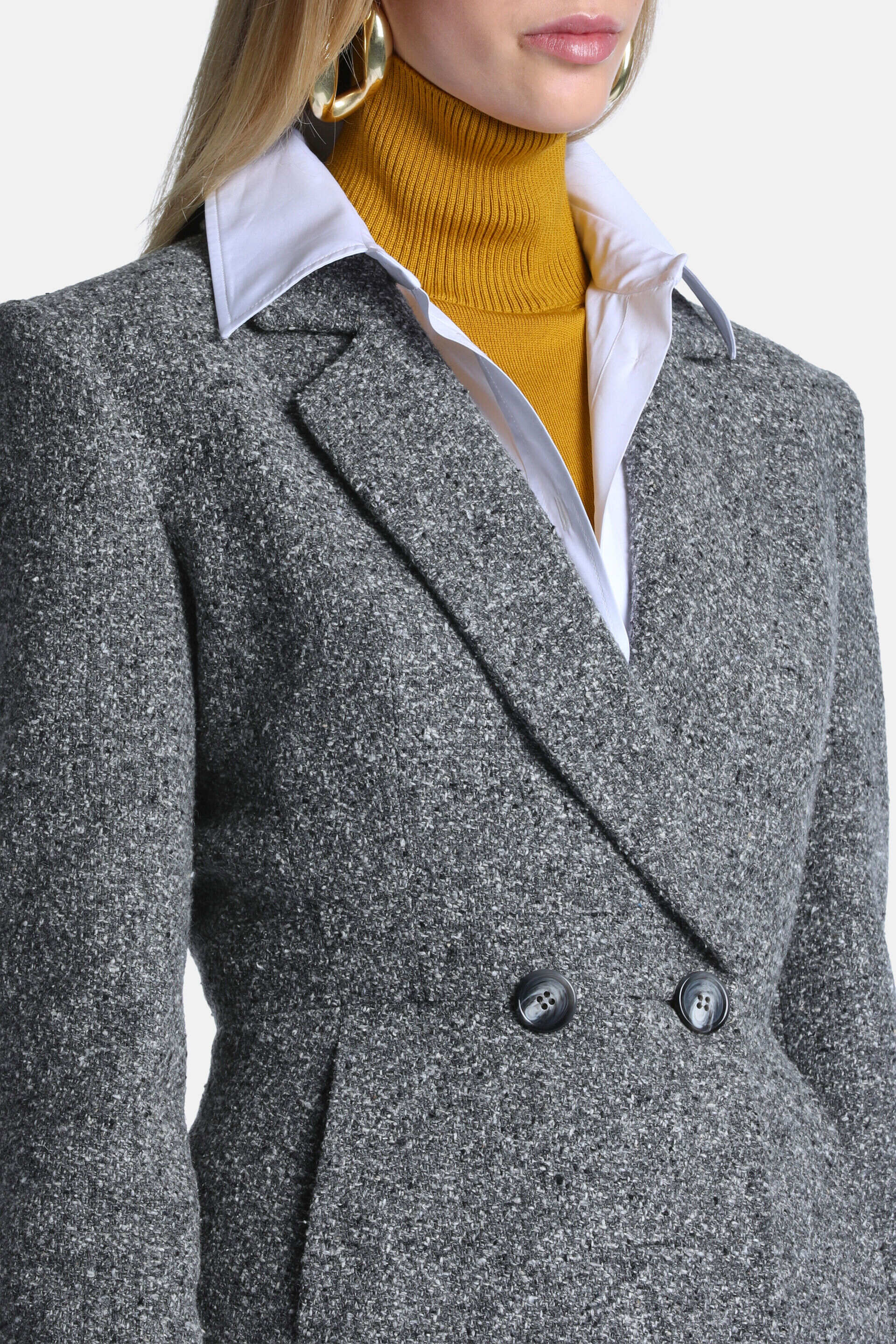 Grey-cream flecked double-breasted jacket with notched lapels, two dark grey buttons, and a visible pocket opening.