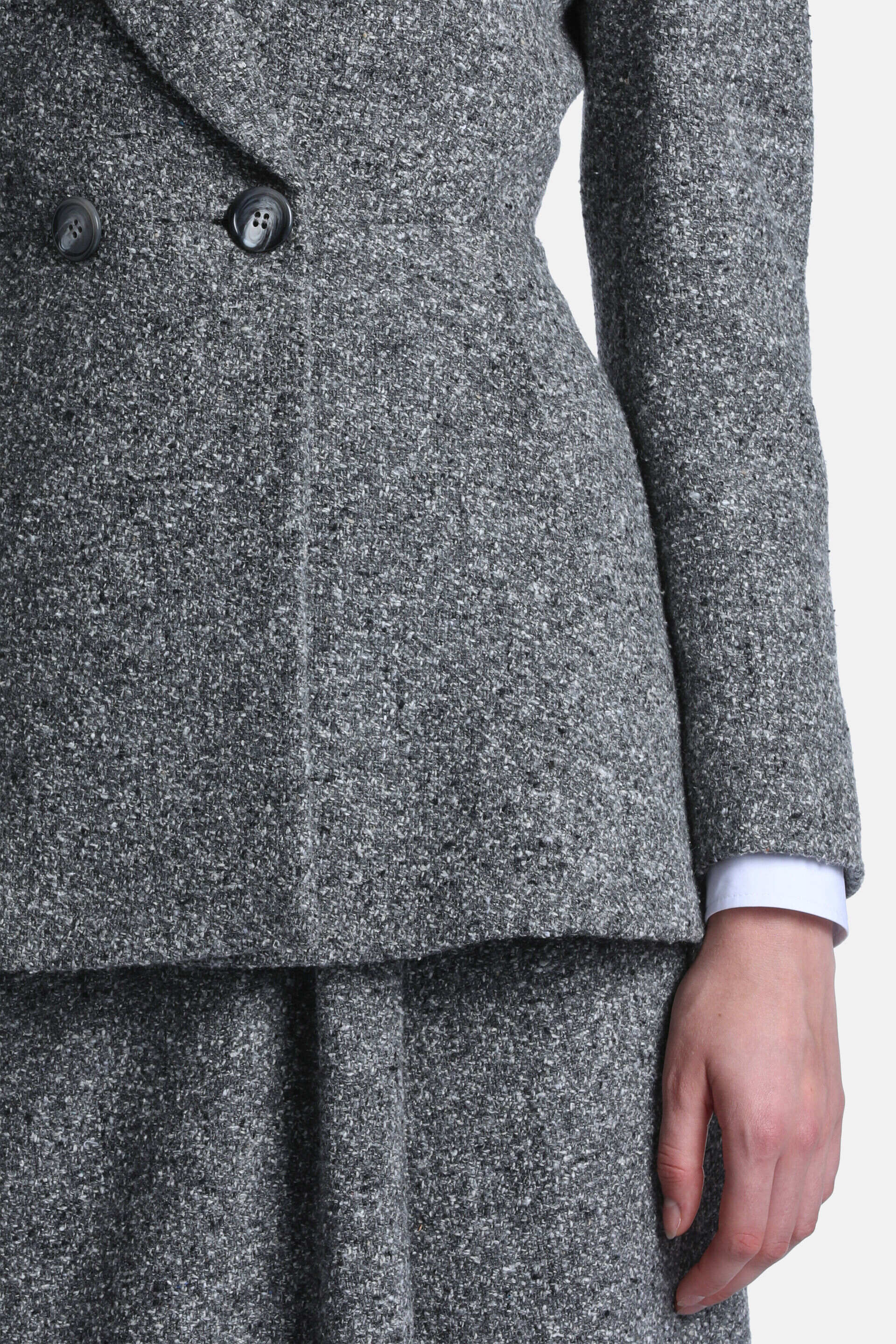 Grey tweed double-breasted jacket with speckled texture, two dark grey buttons, and a tailored fit.