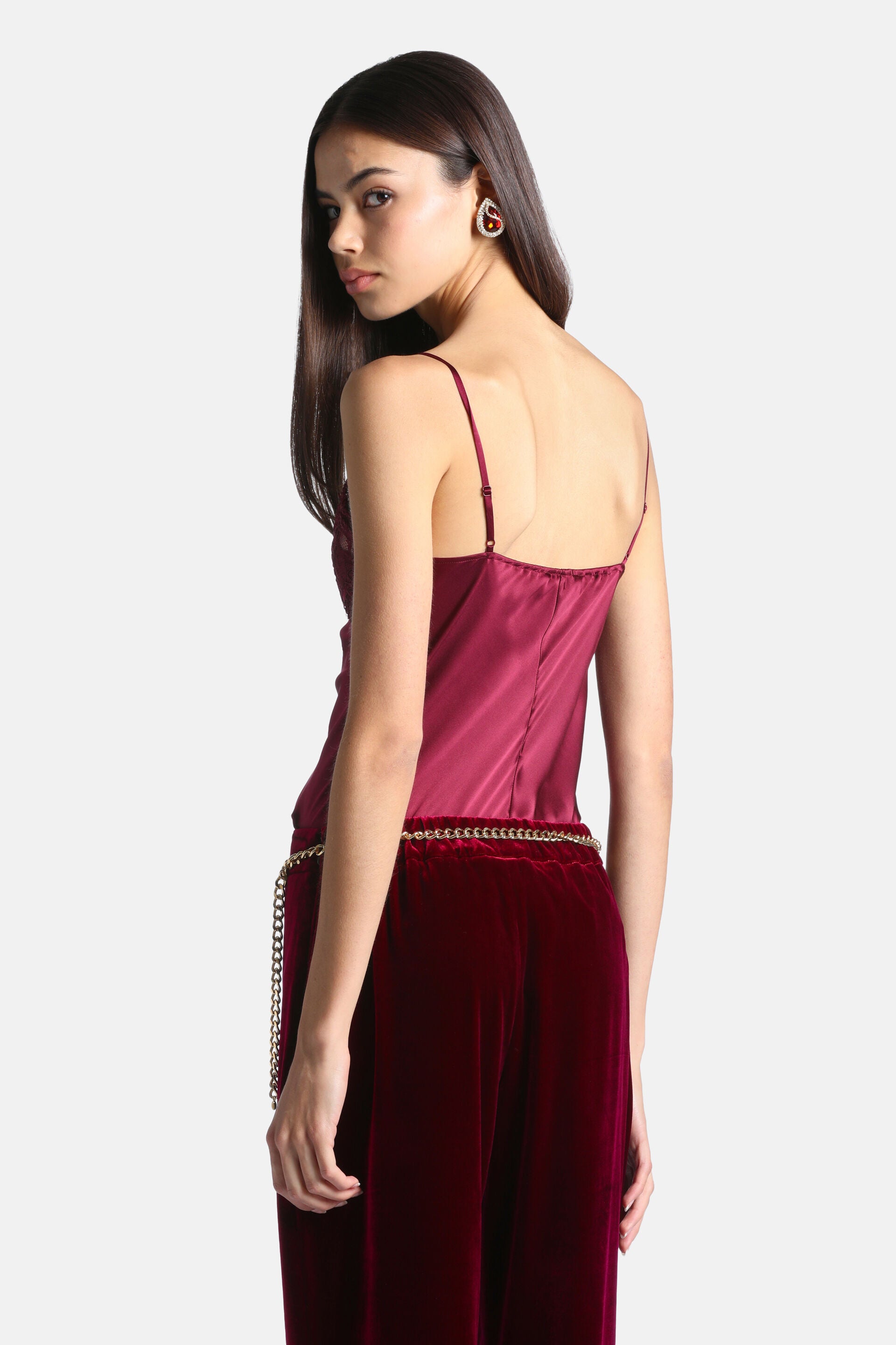 Deep red silky camisole top with thin adjustable spaghetti straps and a straight back neckline.