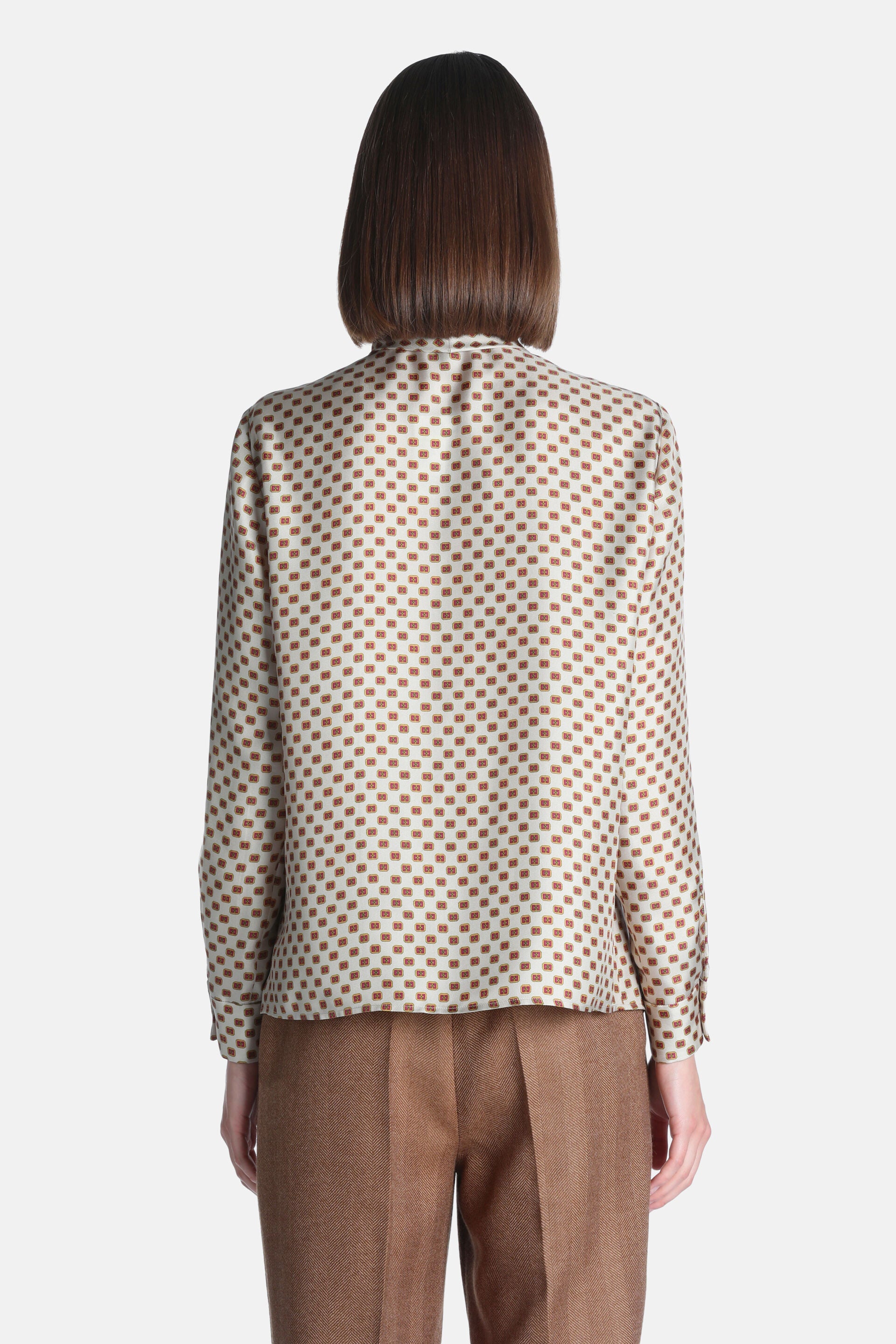 Cream silk shirt with a repeating pattern of small reddish-brown squares. Long sleeves with buttoned cuffs.
