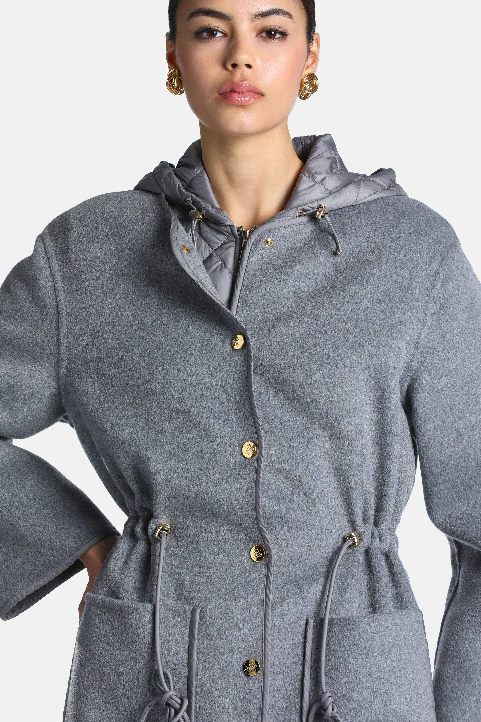 Grey melange coat with a quilted inner hood, gold-toned buttons, drawstring waist with gold-toned eyelets, and front patch po