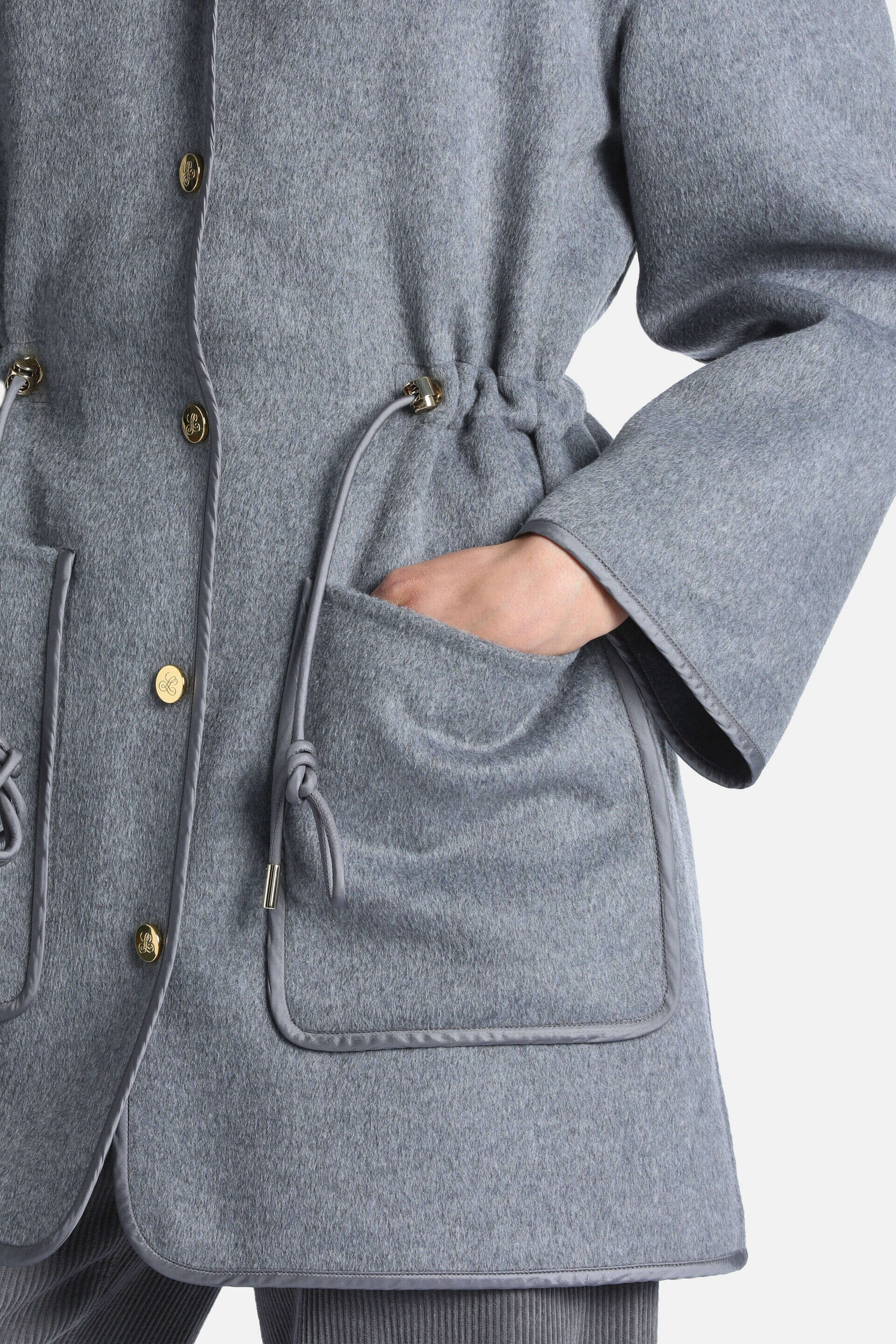 Felted grey melange coat with gold-toned buttons, a cinched drawstring waist with gold-toned toggles, and trimmed patch pocke