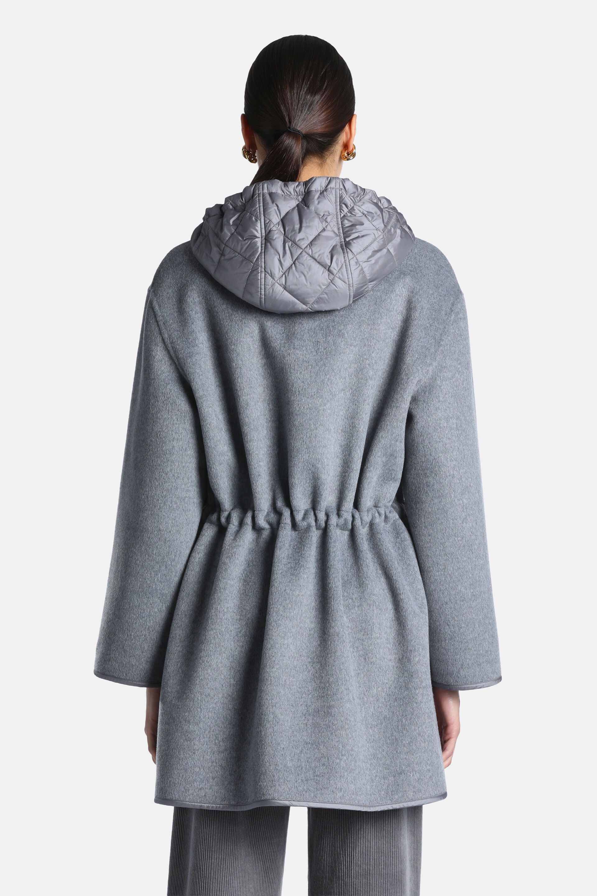 Grey melange coat with a quilted grey hood and a cinched drawstring waist at the back. Wide sleeves and a finished hem.