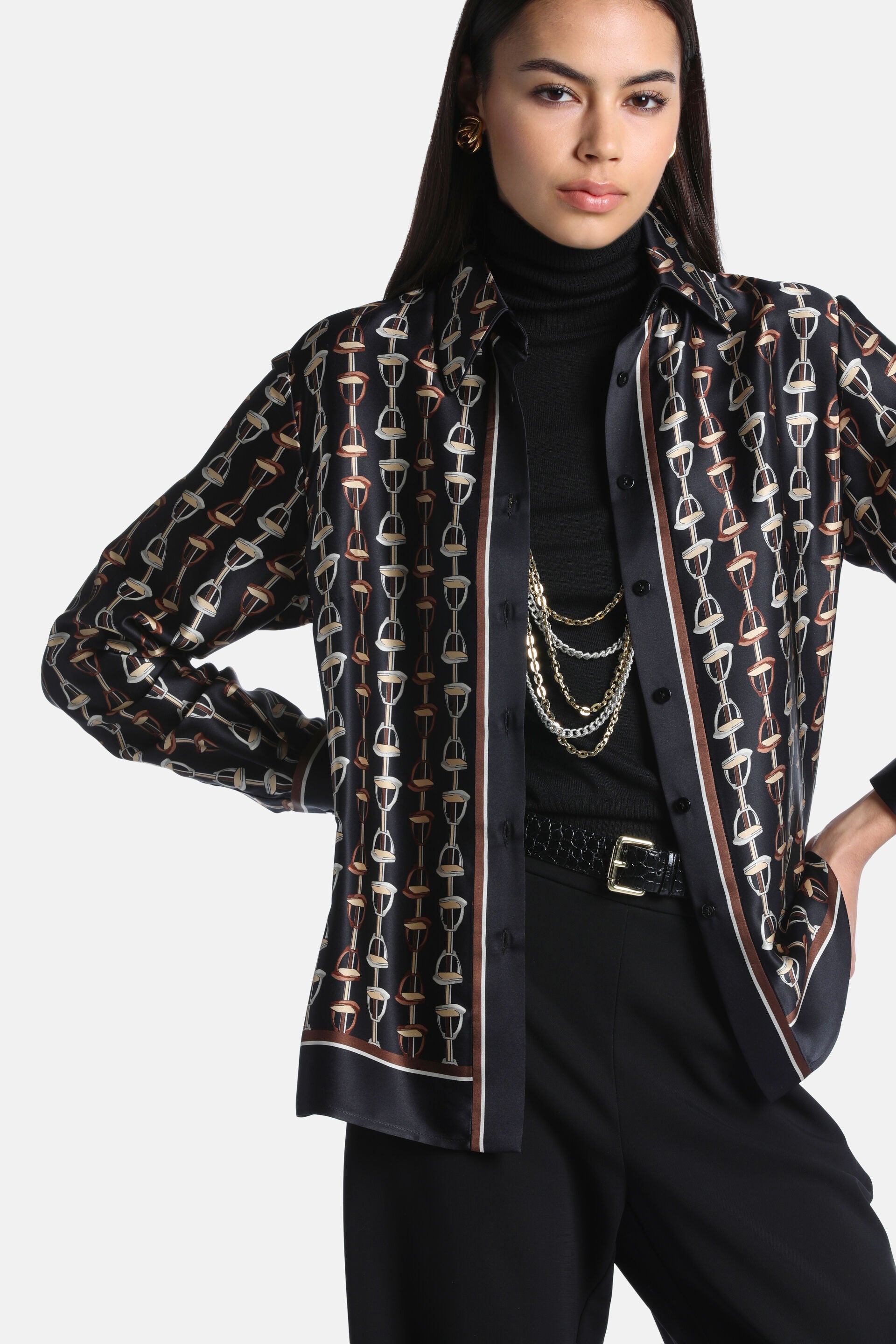 Black silk shirt with an equestrian print of vertical chains of beige, cream, and brown horse bits. Brown and cream stripes.