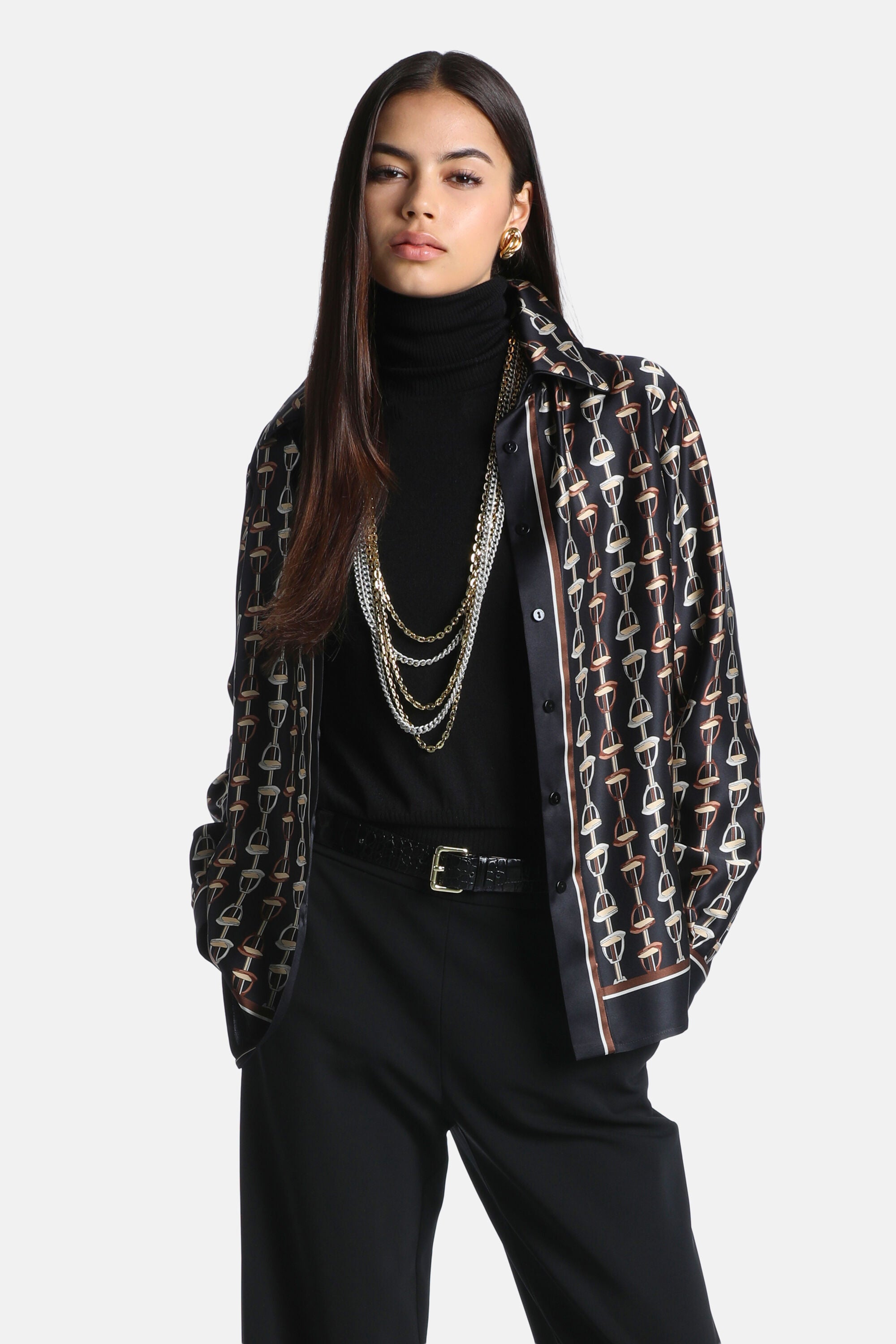 Black silk shirt with an equestrian horse bit pattern in brown and beige. It has a collar, long sleeves, and a vertical strip