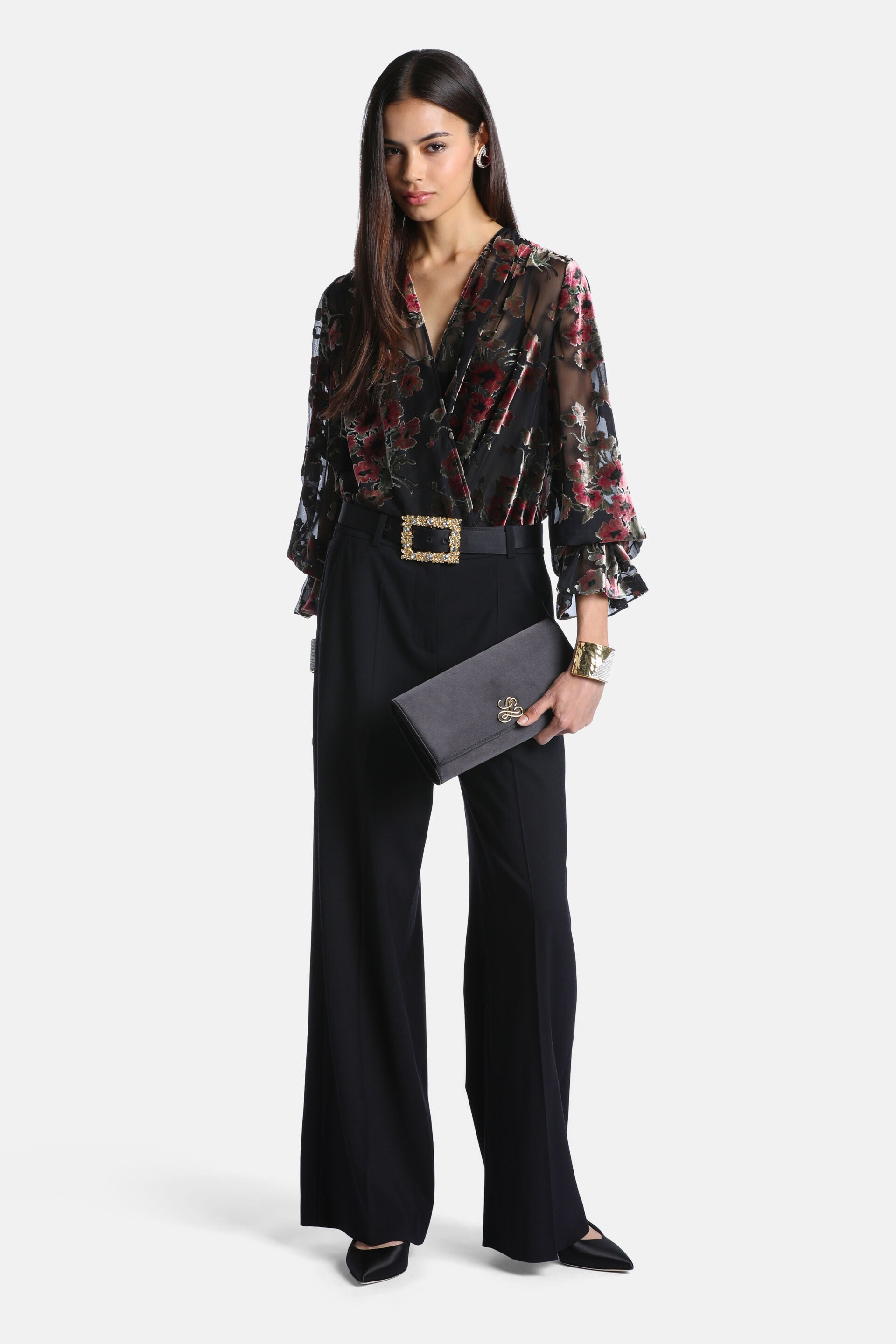 Black sheer wrap shirt with pink and red velvet floral pattern, V-neck, and long sleeves with ruffled cuffs.