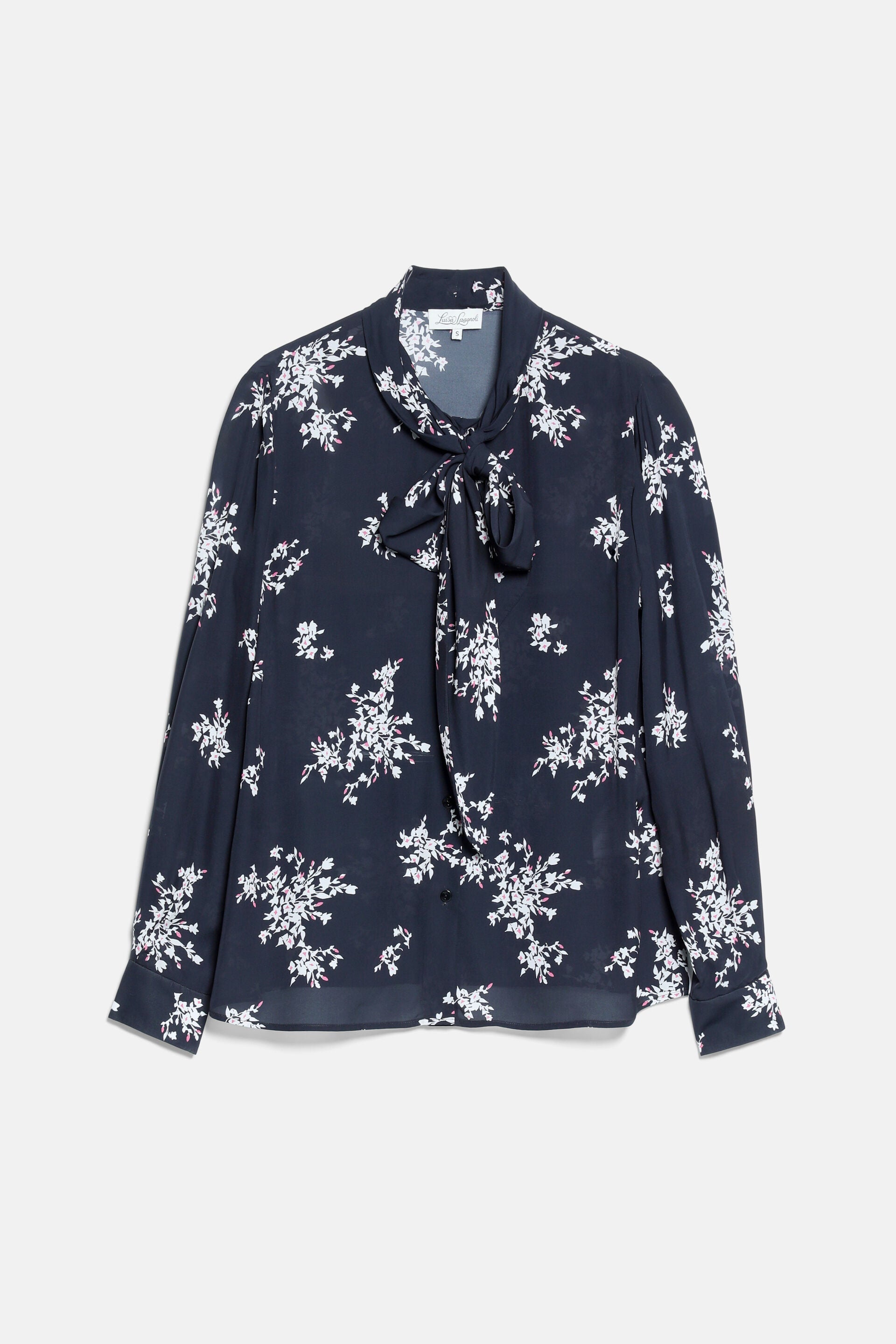 Black long-sleeved blouse with a pussy-bow tie neck. Features a cream and pink floral print and buttoned cuffs.