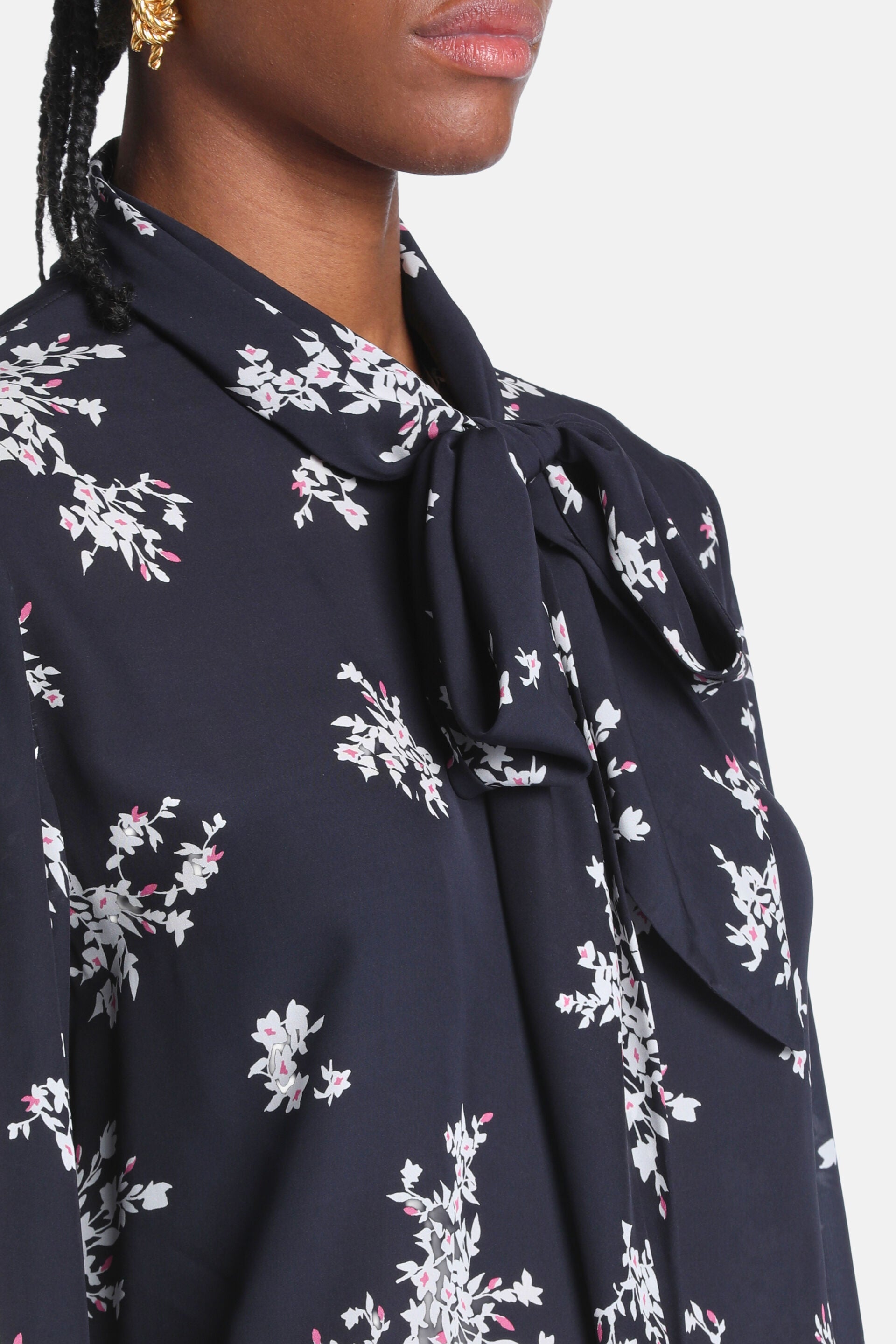 Black shirt with cream and pink floral print, featuring a tied pussy-bow collar.
