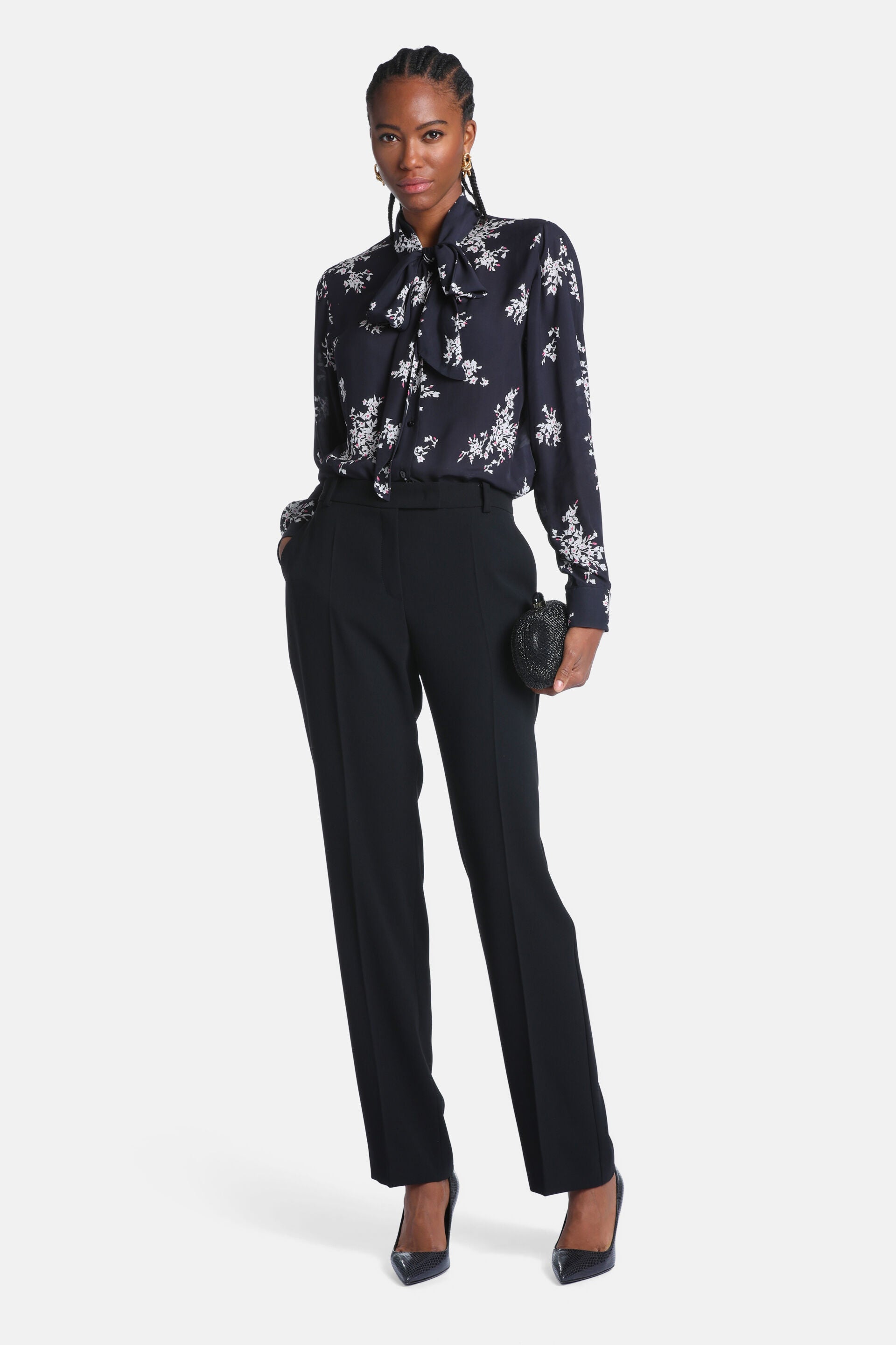 Black long-sleeved shirt with white floral print and a pussy-bow collar.