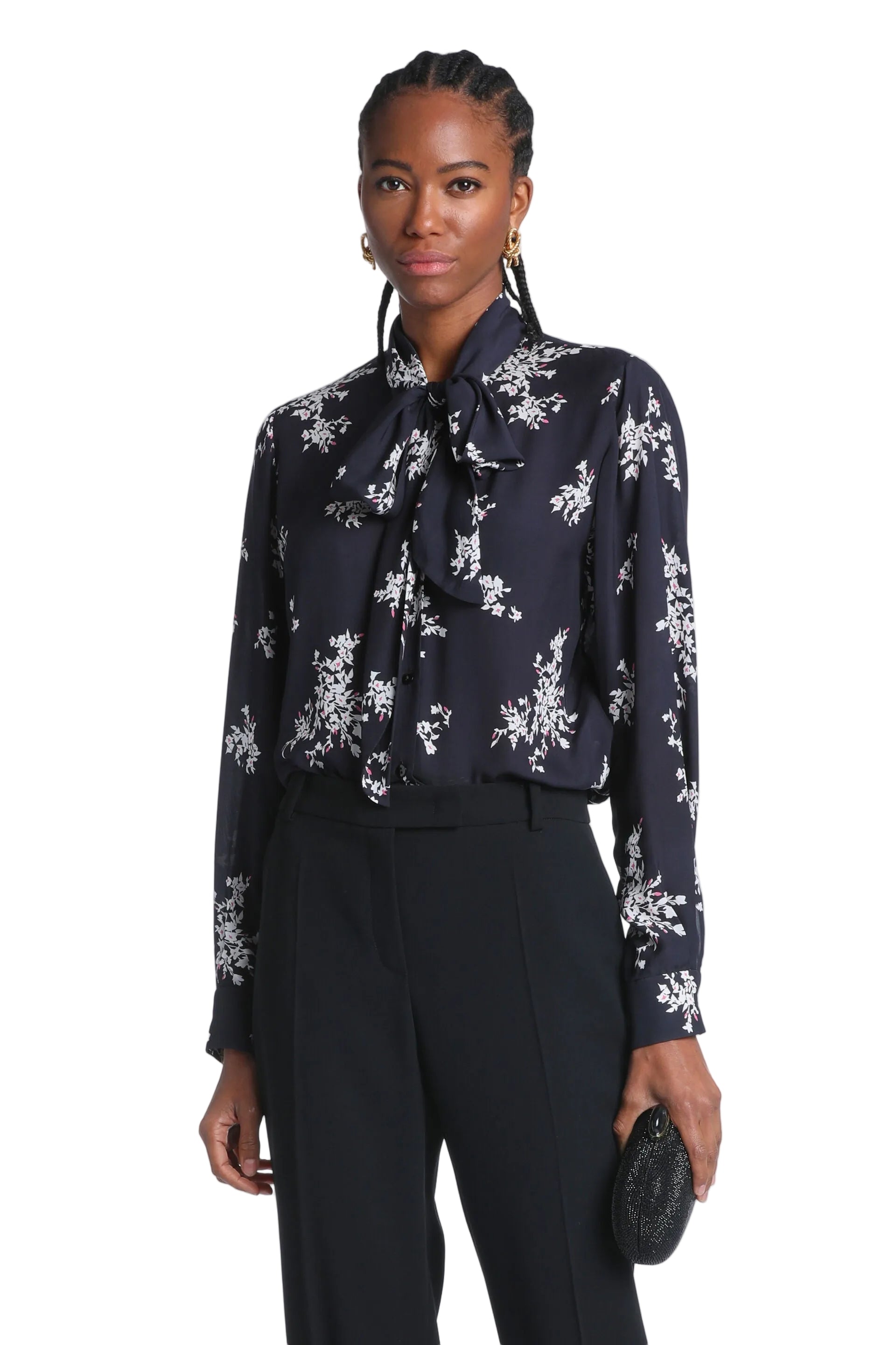 Navy long-sleeved pussy-bow shirt with white and pink floral print and button-front closure.