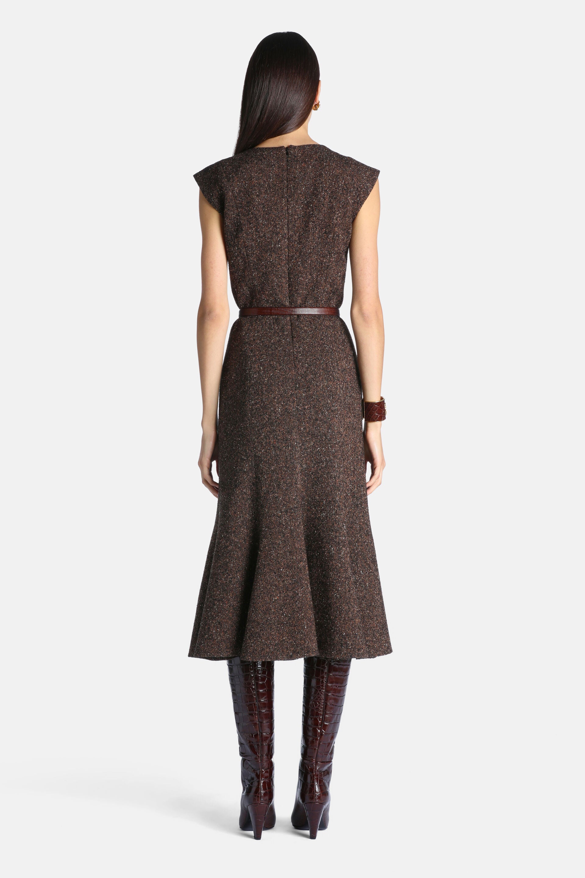 Brown tweed-like midi dress with cap sleeves, a round neck, and a flared mermaid hem. It has a thin braided dark brown belt a