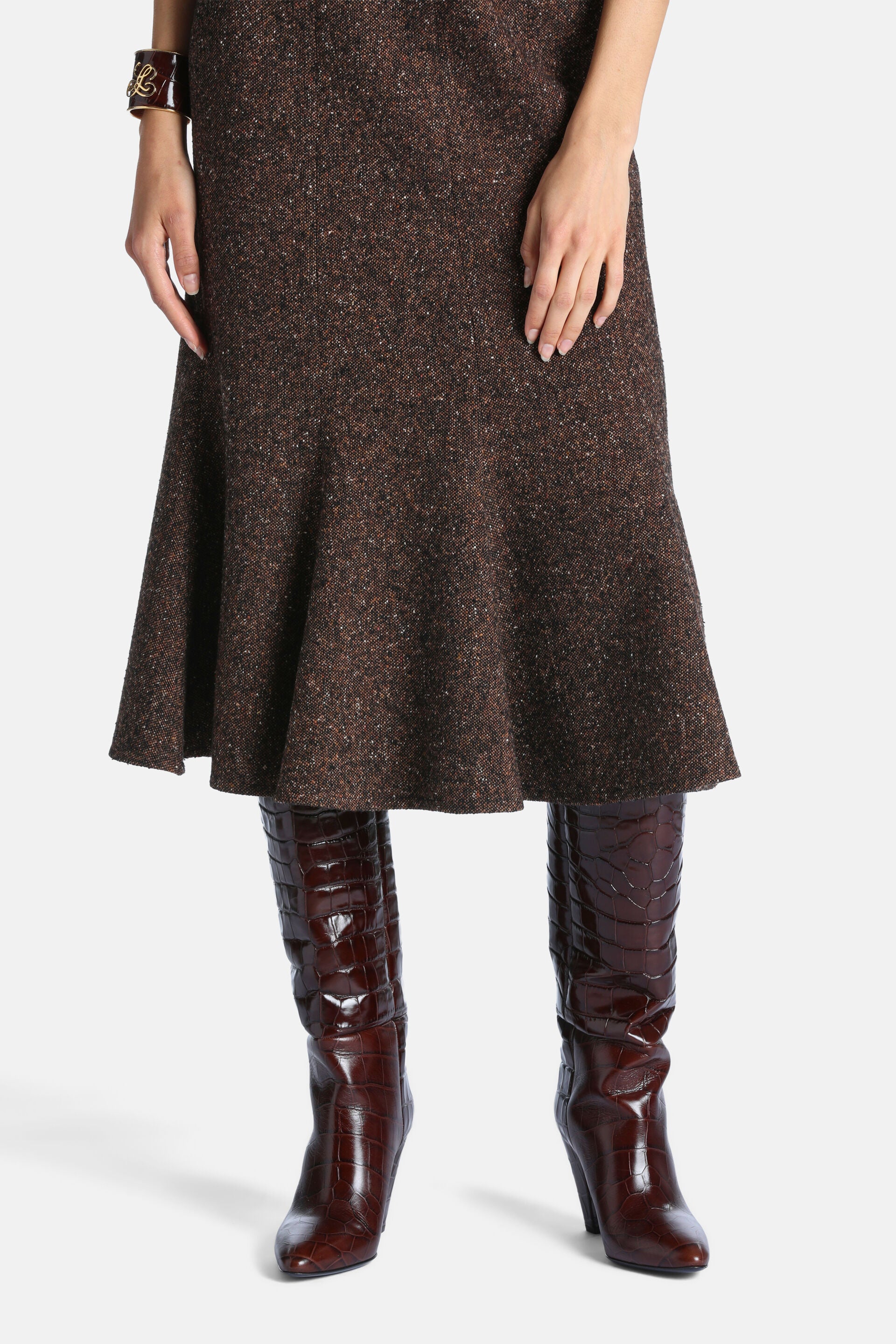 Brown speckled midi dress with a flared, ruffled hem and a vertical front seam.