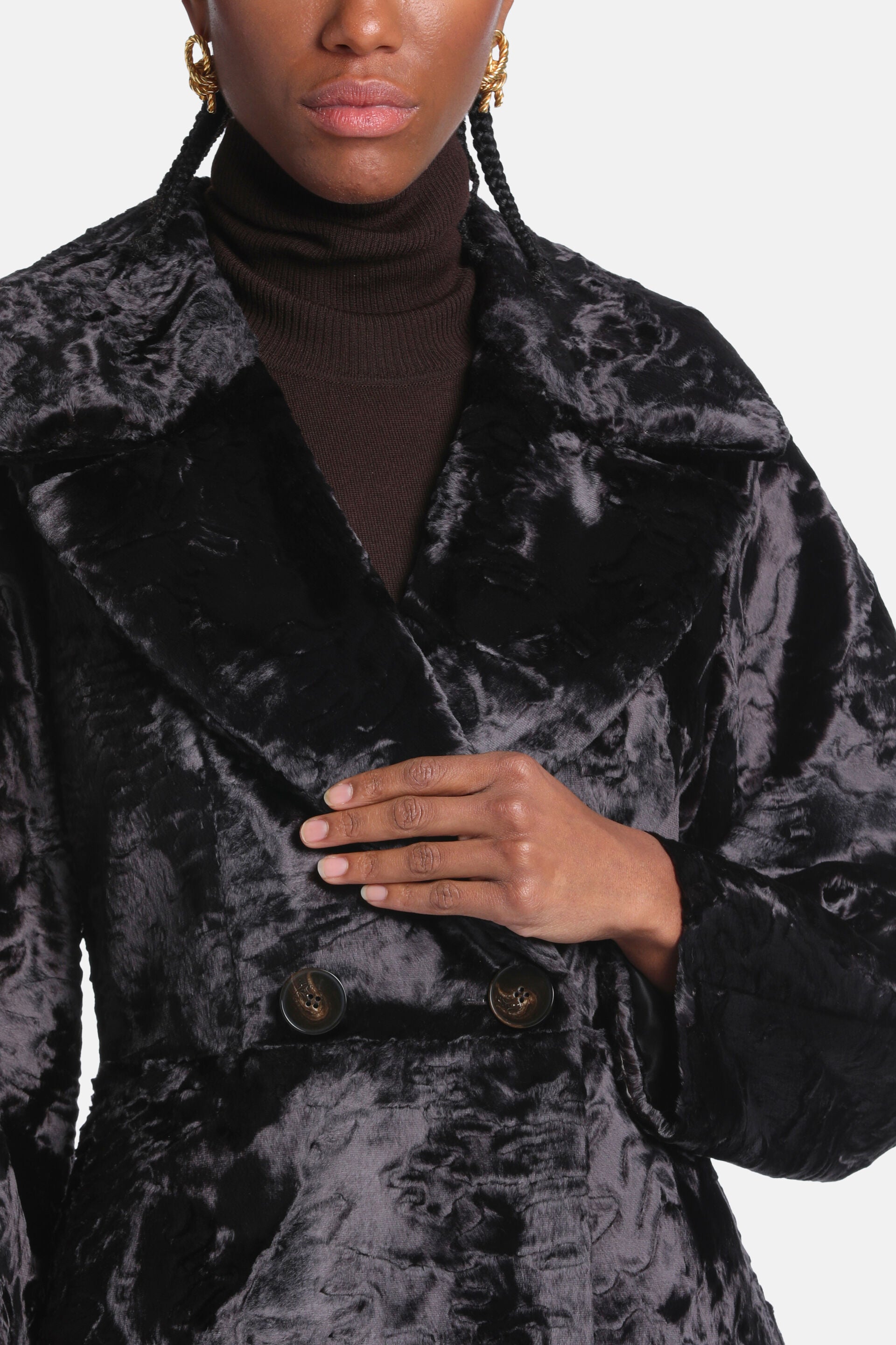Dark brown curly faux fur coat with wide lapel collar and two visible dark brown swirled buttons.