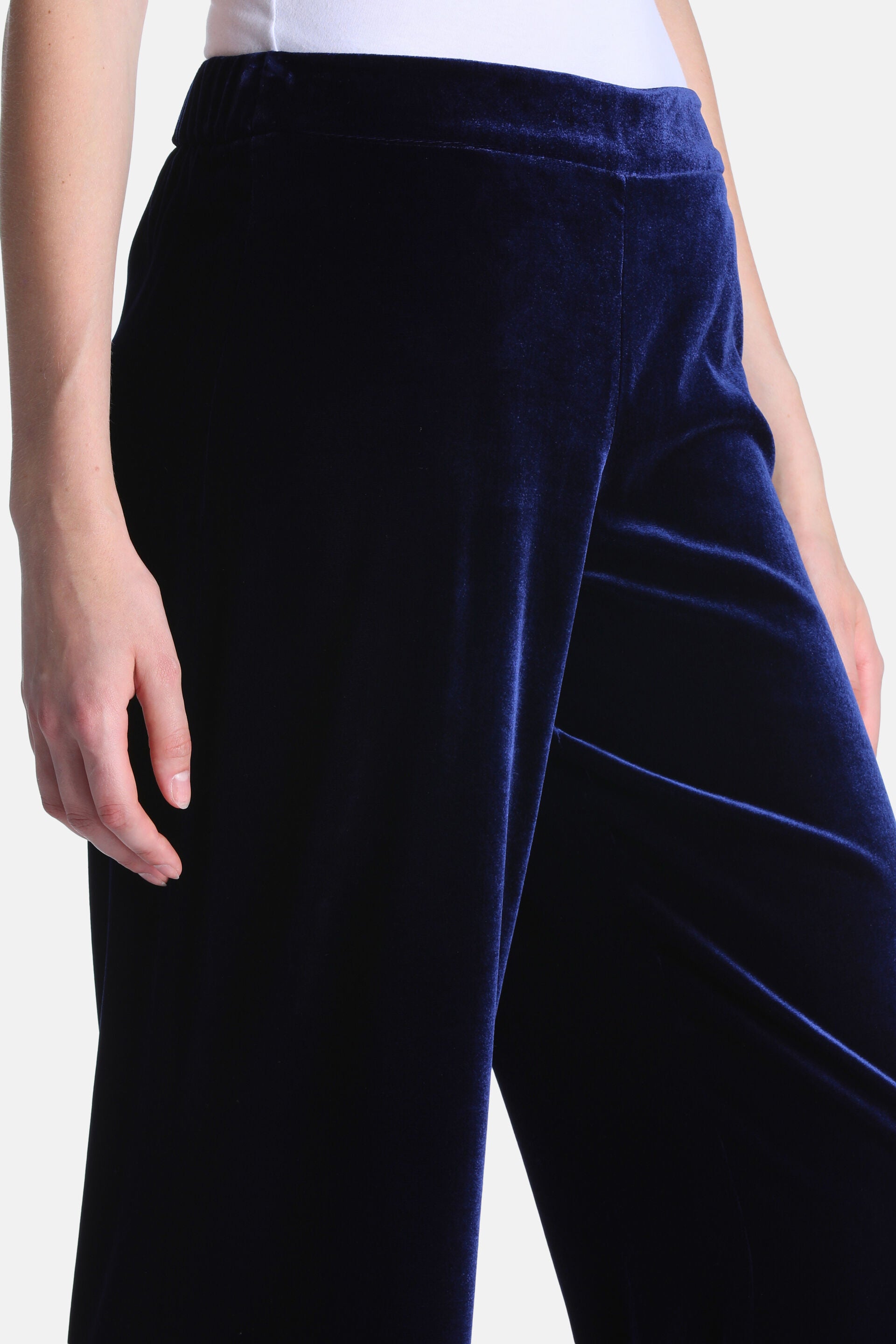 Dark blue velvet trousers with an elasticated waistband and straight, flowing legs.