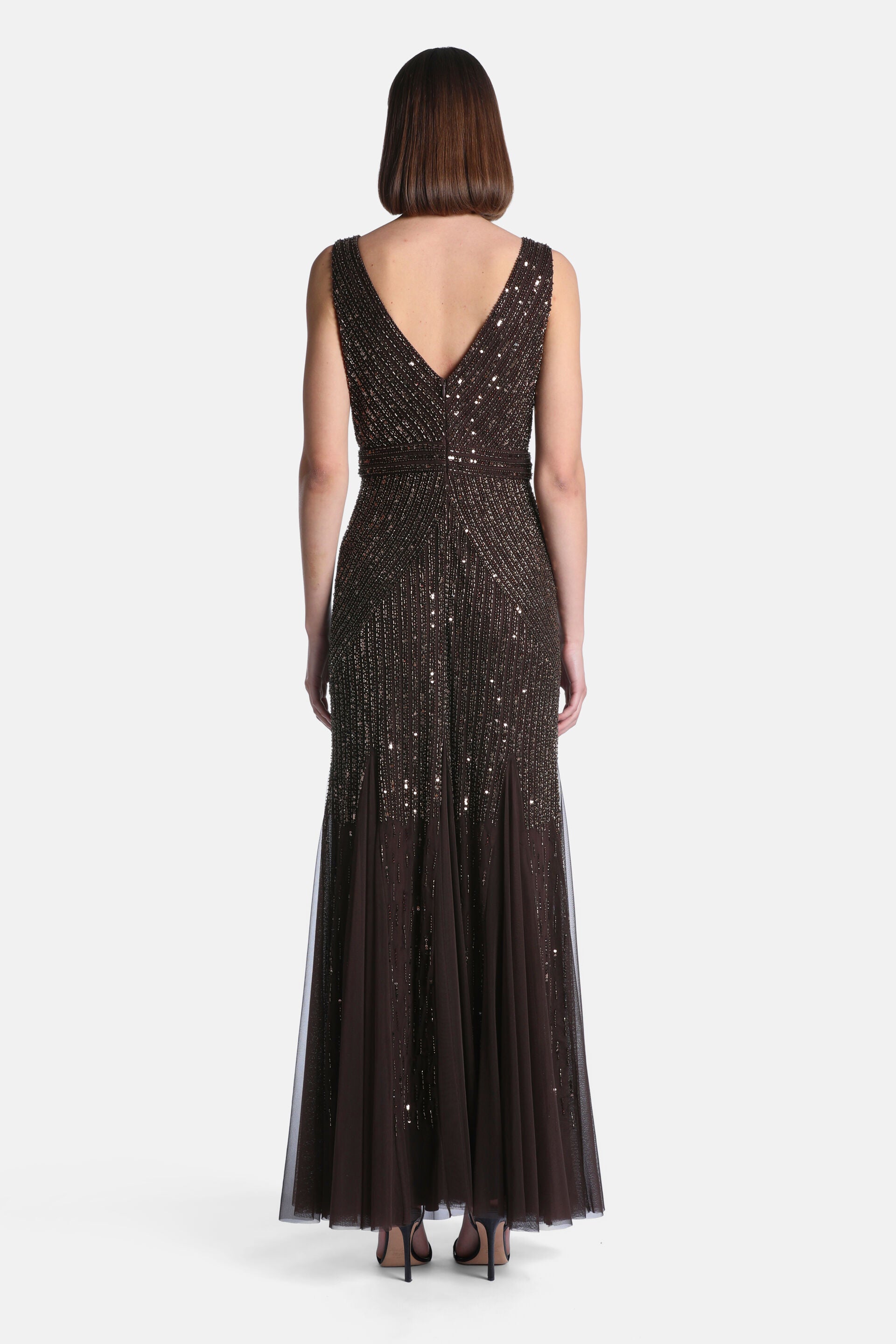 Dark brown sleeveless V-neck gown, fully beaded with gold-toned sequins, and a flowing tulle skirt.