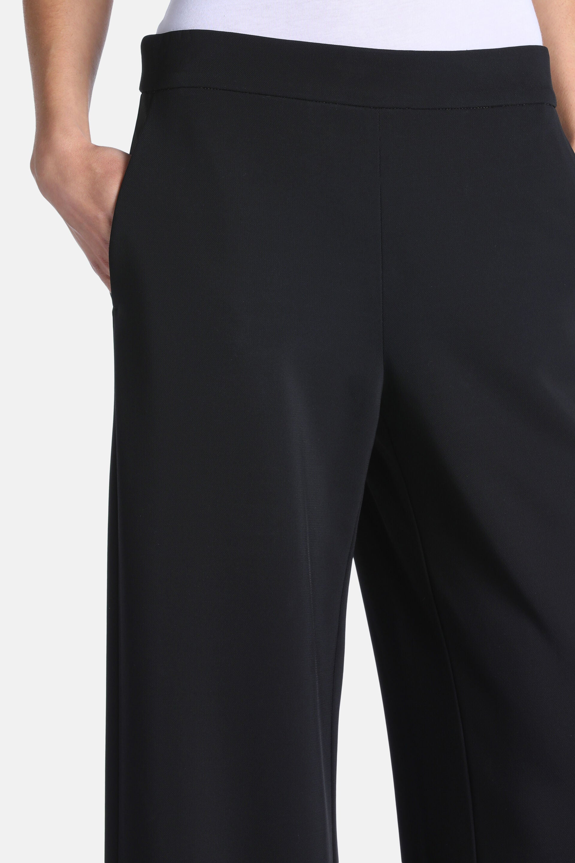 Black wide-leg trousers with a flat waistband and side pockets.