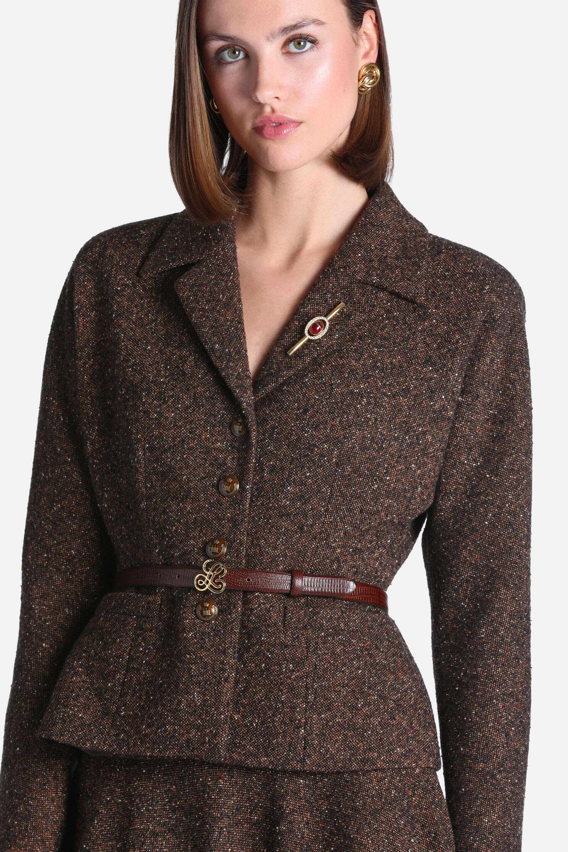 Brown tweed jacket with a lapel collar, three dark brown buttons, and a peplum hem.