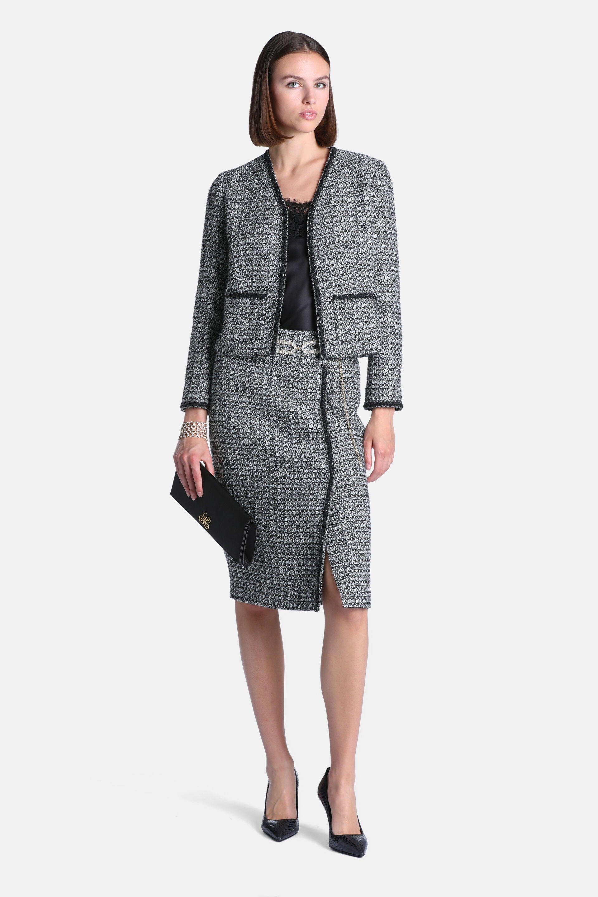 Black and cream tweed pencil skirt with a front left slit and black trim.
