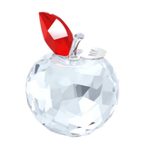 Faceted clear crystal apple figurine with a red crystal leaf, clear stem, and a silver-toned disc engraved with "NY".