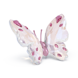 Pink Swarovski crystal butterfly figurine with faceted wings and a smooth pink body.