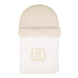 Beige Aigner Kids baby nest with a textured upper panel and a smooth lower panel featuring a gold-toned brand logo.