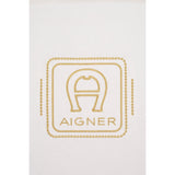 Beige fabric with gold-toned embroidered Aigner logo: a horseshoe-like 'A' inside a rounded rectangle, 'AIGNER' below, framed