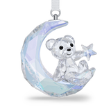 Faceted clear crystal Kris Bear ornament sitting on a crescent moon, holding a star, with iridescent blue and purple reflecti