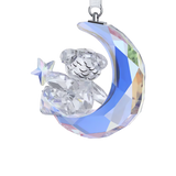 Faceted crystal Kris Bear figurine sitting on a blue-tinted crescent moon, holding a star. Silver-toned hanging loop.