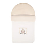 Beige baby nest with a rounded hood, a textured upper band, and a central graphic of a teddy bear with the Aigner logo.