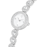 Silver-toned watch with a white dial, crystal-encrusted bezel, and a bracelet strap featuring round crystal-set links.