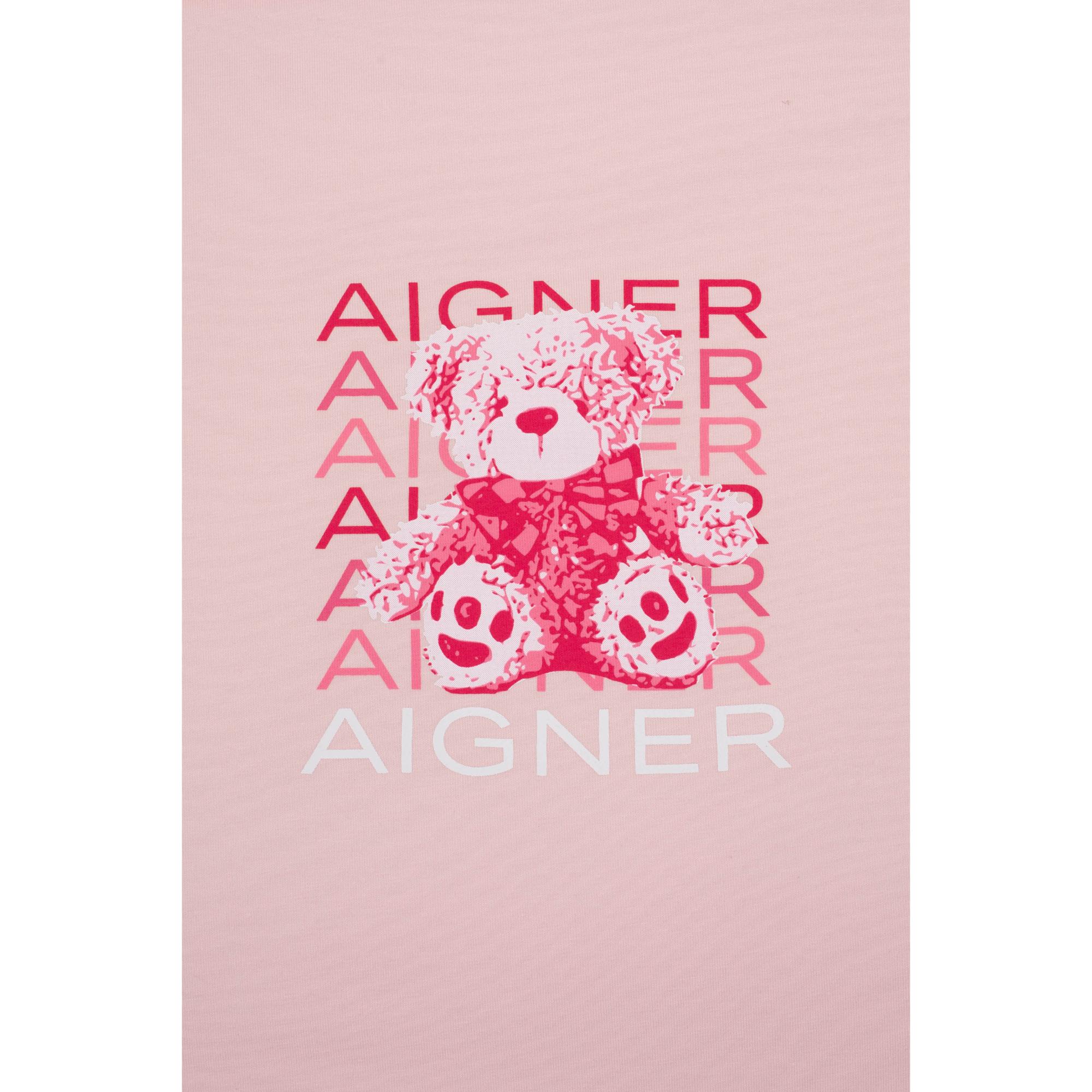 Pink baby nest with a graphic print of a pink and white teddy bear wearing a dark pink bow, surrounded by repeated 'AIGNER' t