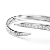 Silver-toned open bangle with two curved ends. One end is pointed, both are set with clear round crystals.