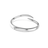 Silver-toned open bangle with a hinged closure. The inner edges of the curved ends are lined with clear stones.