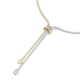 Bolo-style necklace with gold-toned and silver-toned crystal strands through a crystal-encrusted knot. Ends: round and pear c