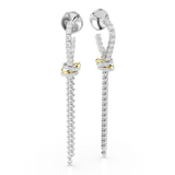 Pair of long drop earrings with silver-toned studs. Each has a crystal-encrusted U-shape knotted around a gold-toned band, wi