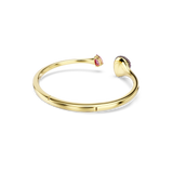 Gold-toned open bangle with a pink teardrop stone on one end and a dome of dark red stones on the other.