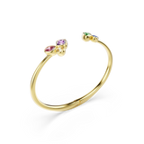 Gold-toned open cuff bangle with a pink, purple, and clear stone cluster on one end, and green and blue stones on the other.