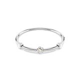 Silver-toned hinged bangle bracelet with three white iridescent star-shaped crystals and pavé-set clear crystals.