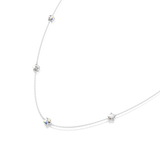 Silver-toned chain necklace with five iridescent, faceted star-shaped beads spaced along its length.